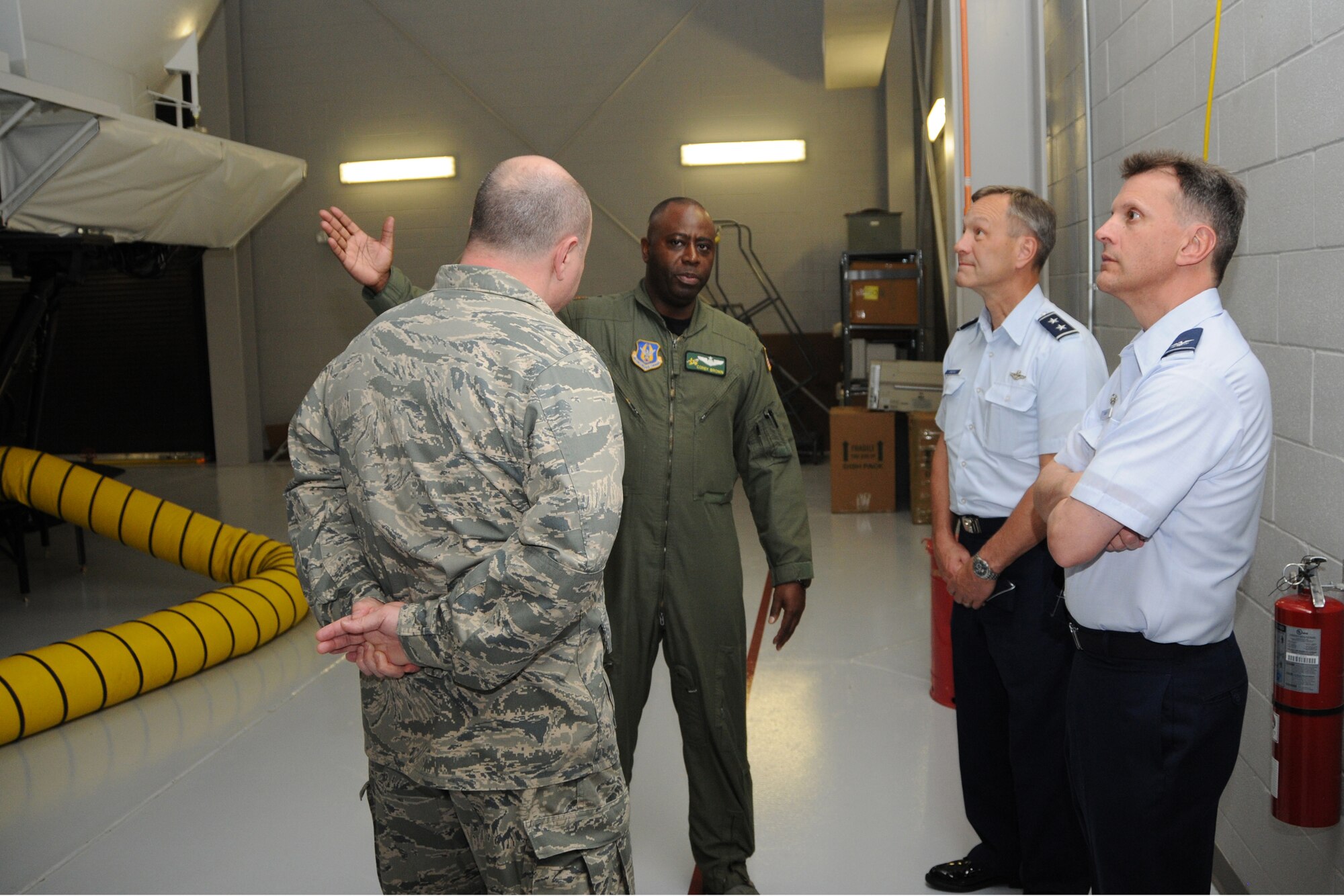 Maj. Corey Brown, pilot with the 77th ARS, talks about the KC-135 simulator to 4AF Commander Maj. Gen. Eric Crabtree and 916th ARW Commander Col. Randall Ogden. (USAF photo by TSgt. Scotty Sweatt, 916ARW/PA)