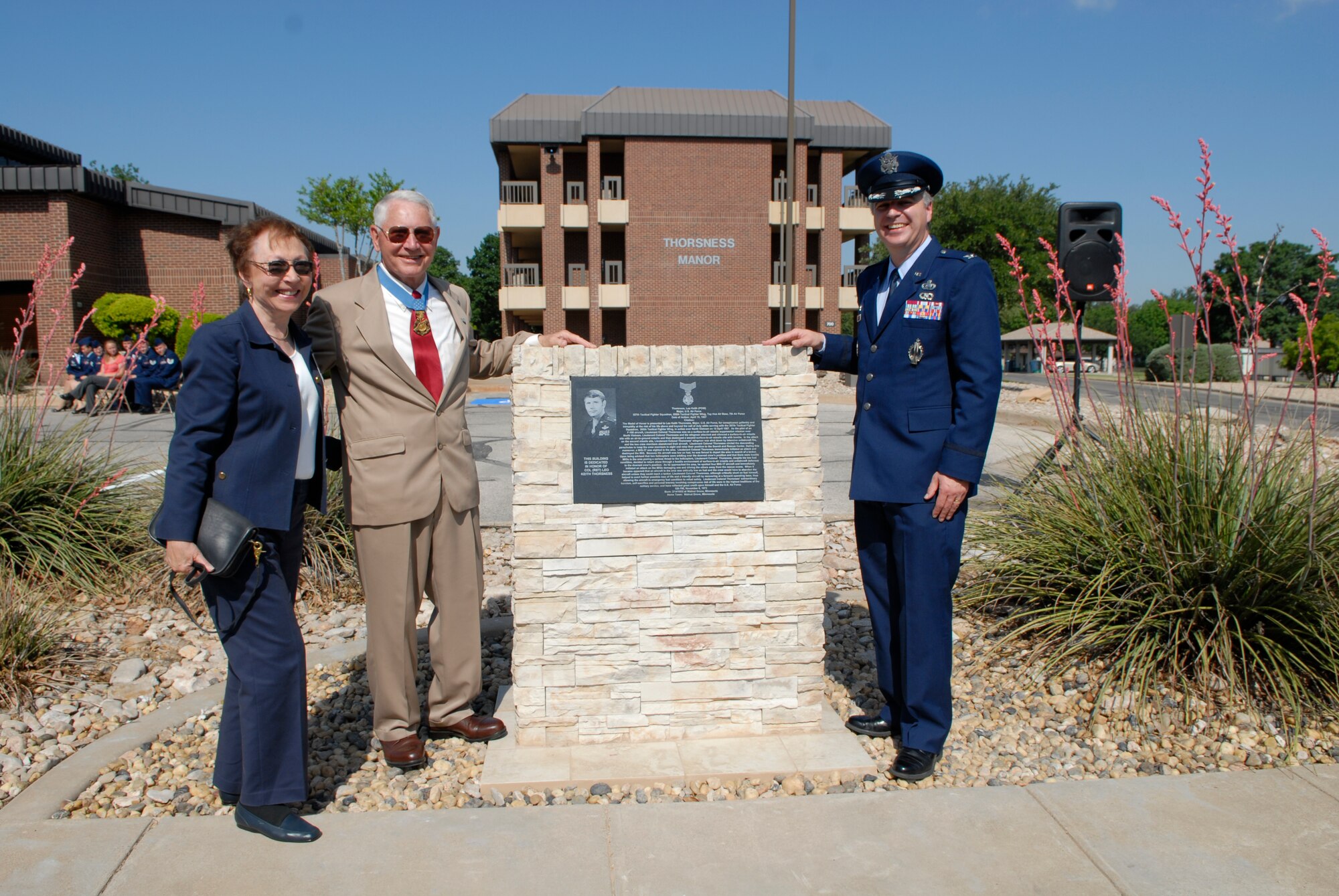 GOODFELLOW AIR FORCE BASE, Texas – Retired Col. Leo K. Thorsness accompanied by his wife Gaylee, and Colonel Thomas Geary, 17th Training Wing commander, unveil the monolith in front of “Thorsness Manor,” May 7, 2010. Two Visiting Officer Quarters were named in honor of retired Colonels Thorsness and George E. “Bud” Day, both of whom received the Medal of Honor for combat actions while serving in Vietnam. (U.S. Air Force photo/Lou Czarnecki)