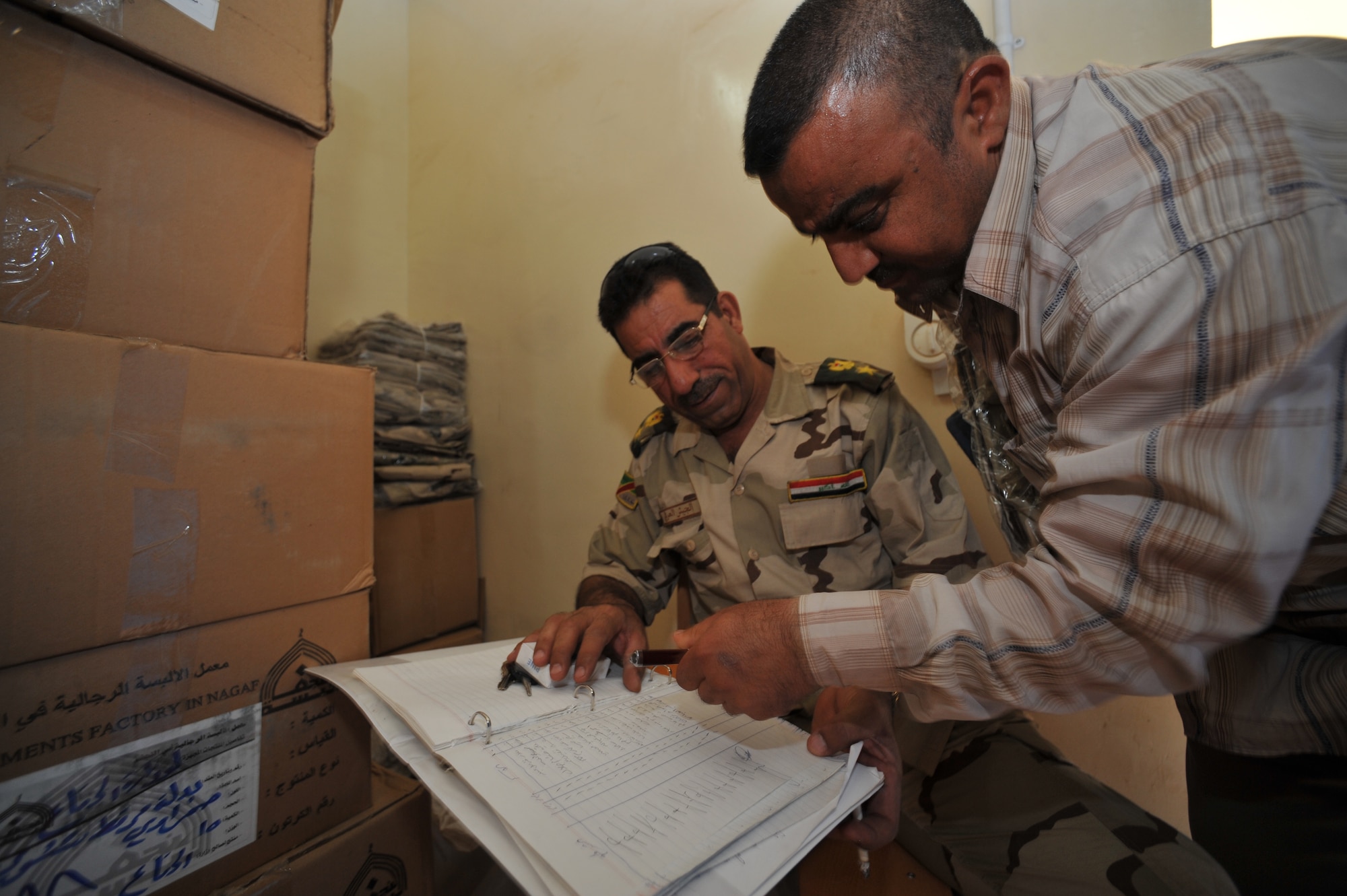 An Iraqi Air Force recruit signs for his uniforms at the Iraqi Air Force Training School, Camp Taji, Iraq, April 19, 2010. The Iraqi airmen volunteered to return to active duty through the rehire program by the Ministry of Defense.  (U.S. Air Force photo/Staff Sgt Quinton Russ/released)