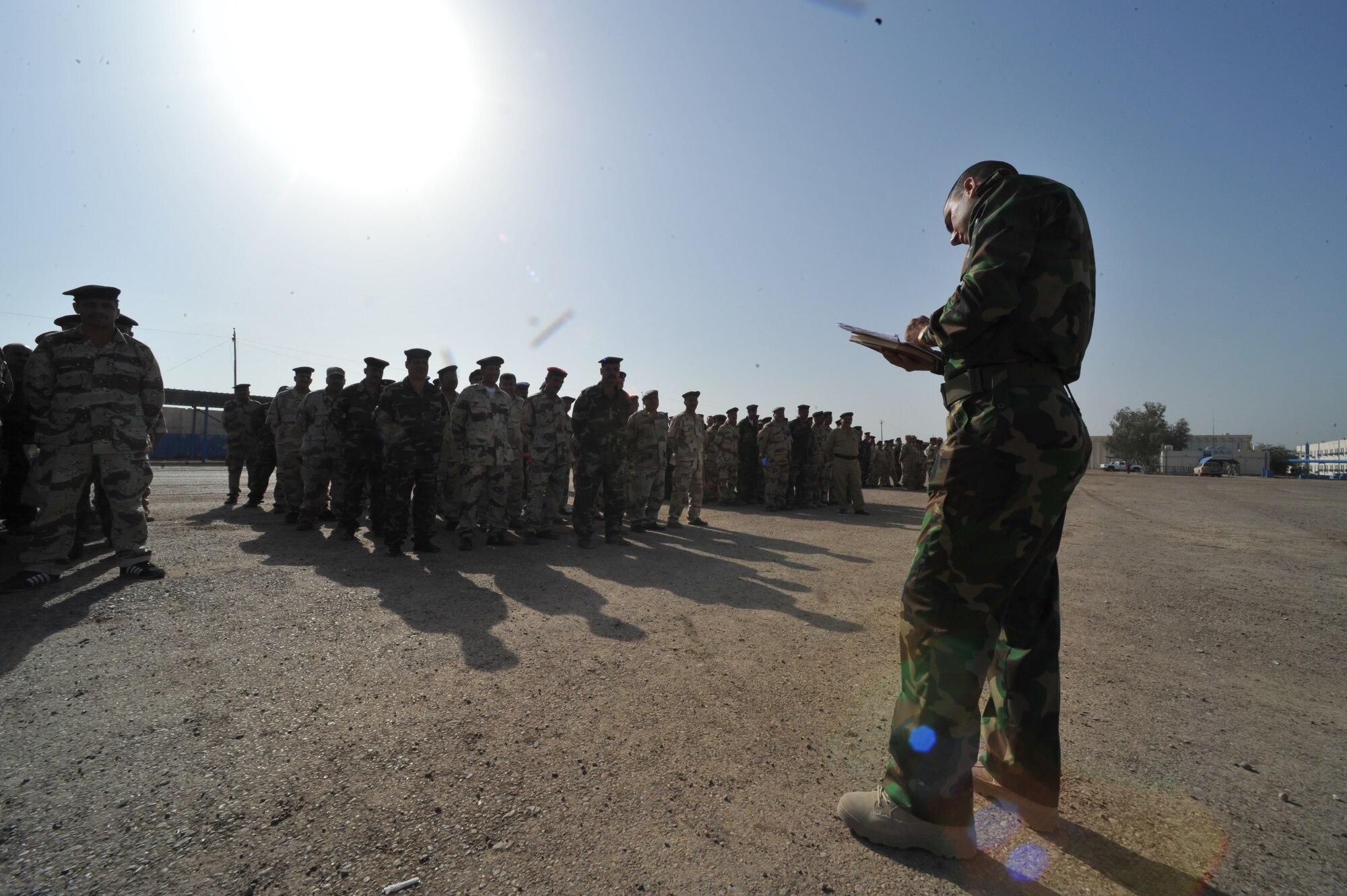 Iraqi Air Force Basic Training Instructor 1st Lt. Ammar Hamed takes roll before conducting drill at the Iraqi Air Force Training School in Camp Taji, Iraq, April 19, 2010. The Iraqi airmen volunteered to return to active duty through the rehire program by the Ministry of Defense.  (U.S. Air Force photo/Staff Sgt Quinton Russ/released)