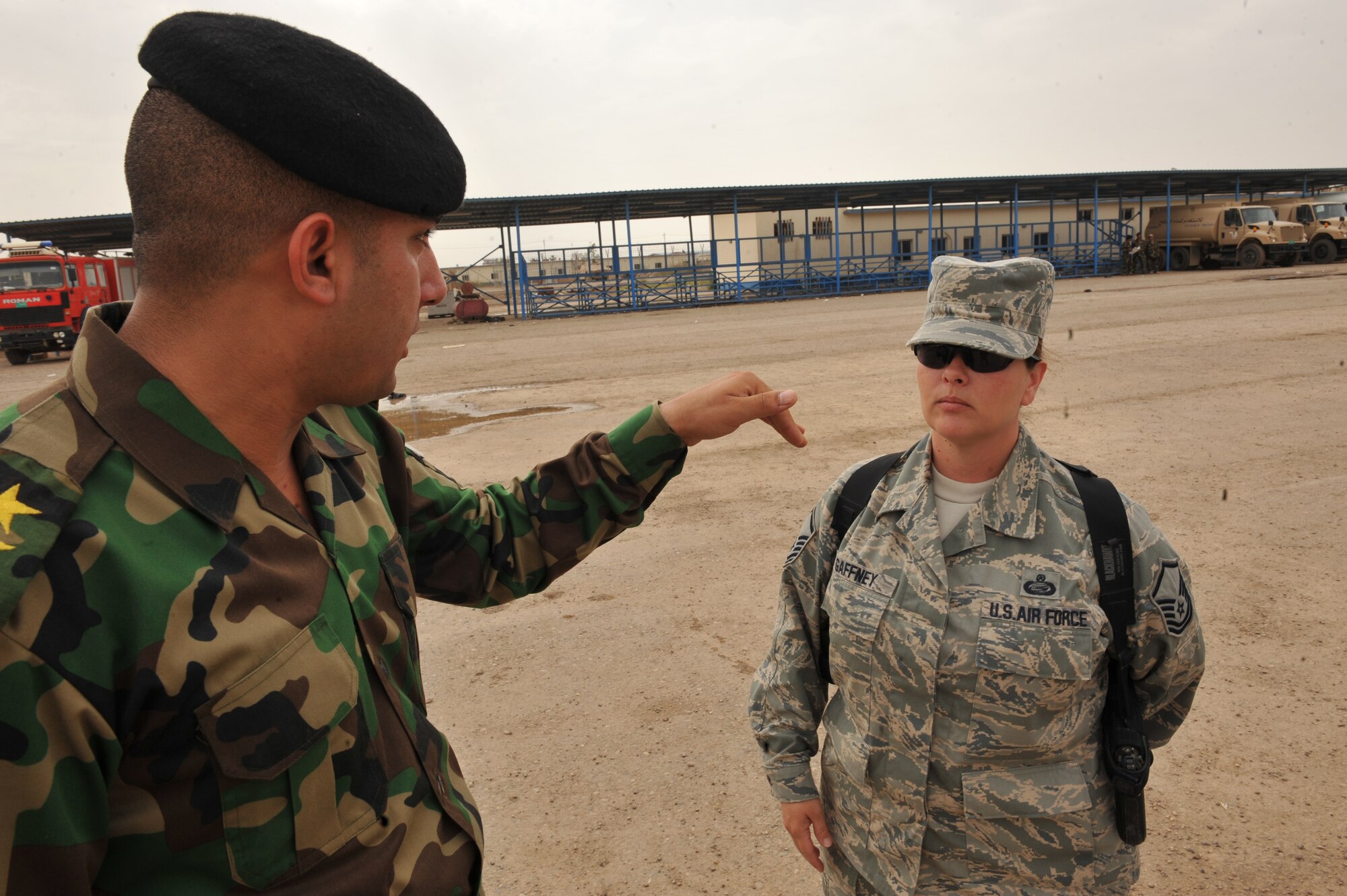 Iraqi Air Force Instructor 1st Lt. Ammar Hamed tells U.S. Air Force Master Sgt. Paula Gaffney the sequence of events for the day's lesson at Camp Taji, Iraq, April 18, 2010. Sergeant Gaffney is a Basic Military Instructor and advisor to the Iraqi Air Force deployed from the 326th Training Squadron, Lackland Air Force Base, Texas. She is forward deployed to the 821st Expeditionary Training Squadron.  (U.S. Air Force photo/Staff Sgt Quinton Russ/released)