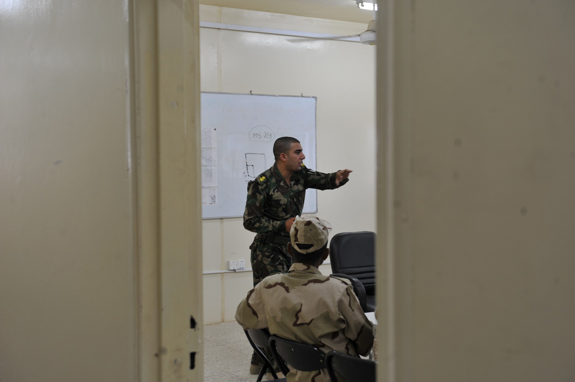 Iraqi Air Force Basic Training Instructor 1st Lt. Ammar Hamed instructs a land-navigation class at the Iraqi Air Force Training School in Camp Taji, Iraq, April 18, 2010. The Iraqi airmen volunteered to return to active duty through the rehire program by the Ministry of Defense.  (U.S. Air Force photo/Staff Sgt Quinton Russ/released)