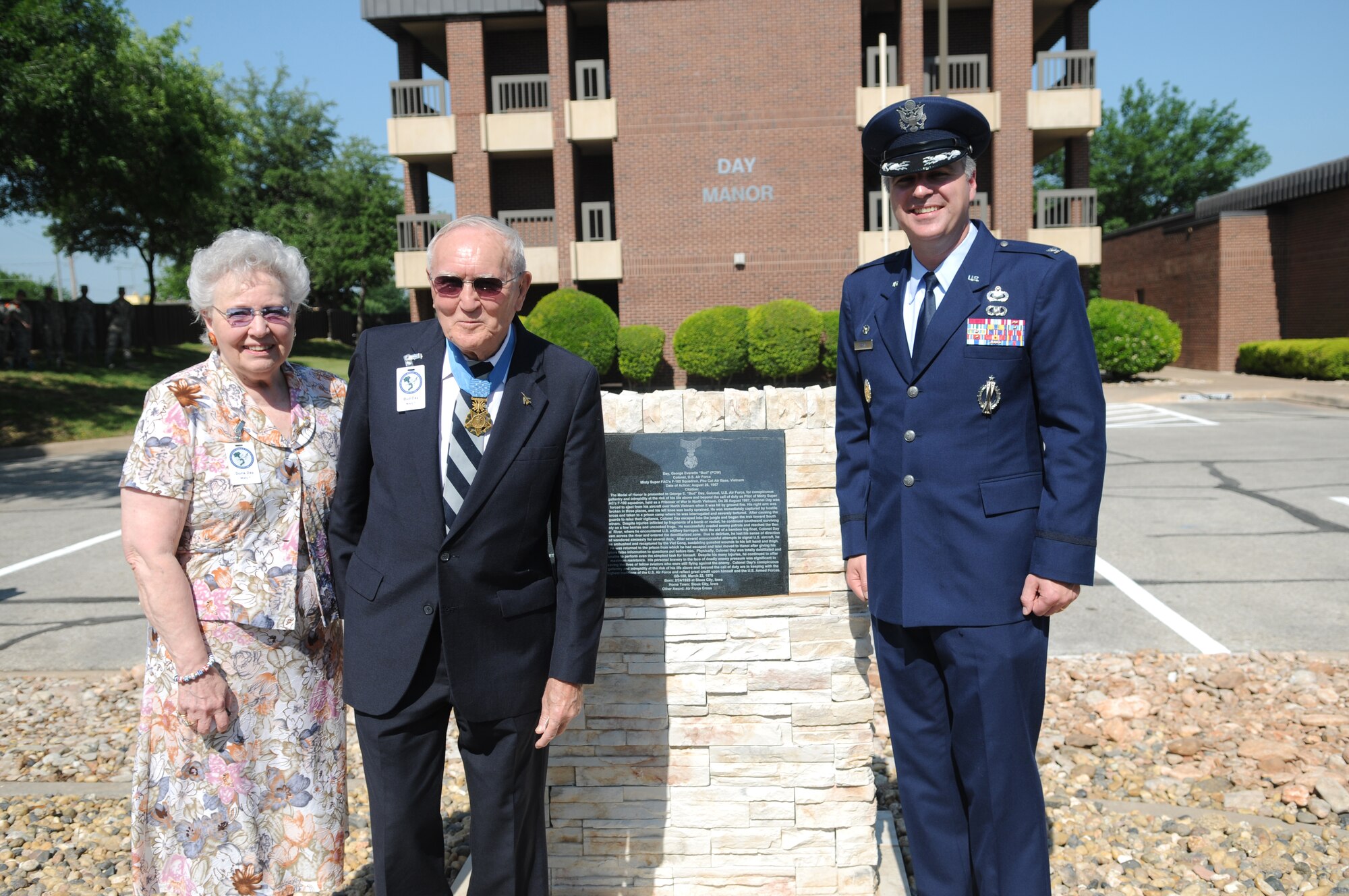 GOODFELLOW AIR FORCE BASE, Texas – Retired Col. George E. “Bud” Day accompanied by his wife Doris, and Colonel Thomas Geary, 17th Training Wing commander, unveil the monolith in front of “Day Manor,” May 7, 2010. Two Visiting Officer Quarters were named in honor of retired Air Force Colonels George Day and Leo K. Thorsness, both of whom received the Medal of Honor for actions while serving in Vietnam. (U.S. Air Force photo/Airman 1st Class Clayton Lenhardt)