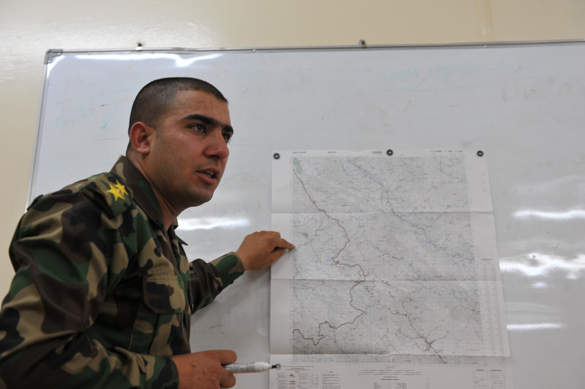 Iraqi Air Force Basic Training Instructor 1st Lt. Ammar Hamed instructs a land-navigation class at the Iraqi Air Force Training School in Camp Taji, Iraq, April 18, 2010. The Iraqi airmen volunteered to return to active duty through the rehire program by the Ministry of Defense.  (U.S. Air Force photo/Staff Sgt Quinton Russ/released)