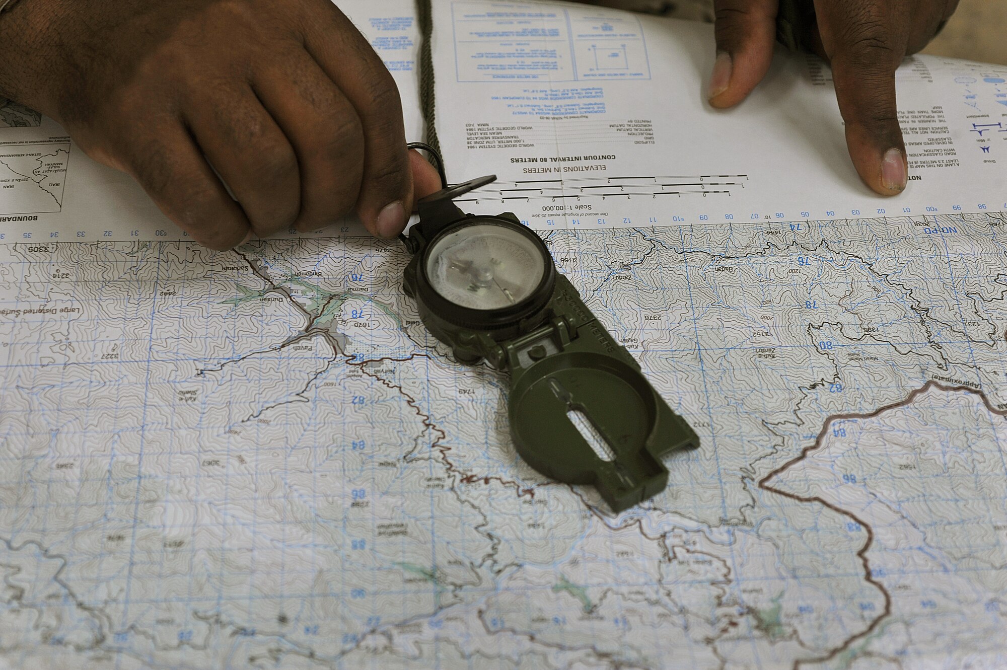 Iraqi Air Force airmen practice using a map and compass during the land navigation portion of their BMT Top Off training at Camp Taji, Iraq, April 18, 2010. The Iraqi airmen volunteered to return to active duty through the rehire program by the Ministry of Defense.  (U.S. Air Force photo/Staff Sgt Quinton Russ/released)