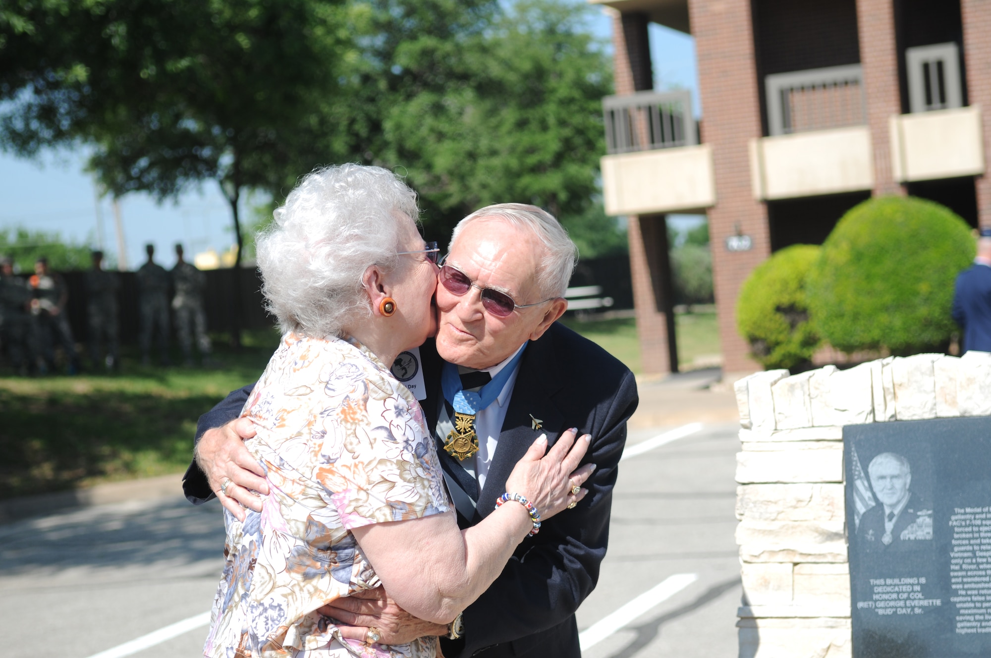 GOODFELLOW AIR FORCE BASE, Texas – Retired Col. George E. “Bud” Day embraces his wife Doris after the unveiling of “Day Manor,” May 7, 2010. Two Visiting Officer Quarters were named in honor of retired Air Force Colonels Day and Leo K. Thorsness, both of whom received the Medal of Honor for actions while serving in Vietnam. (U.S. Air Force photo/Airman 1st Class Clayton Lenhardt)