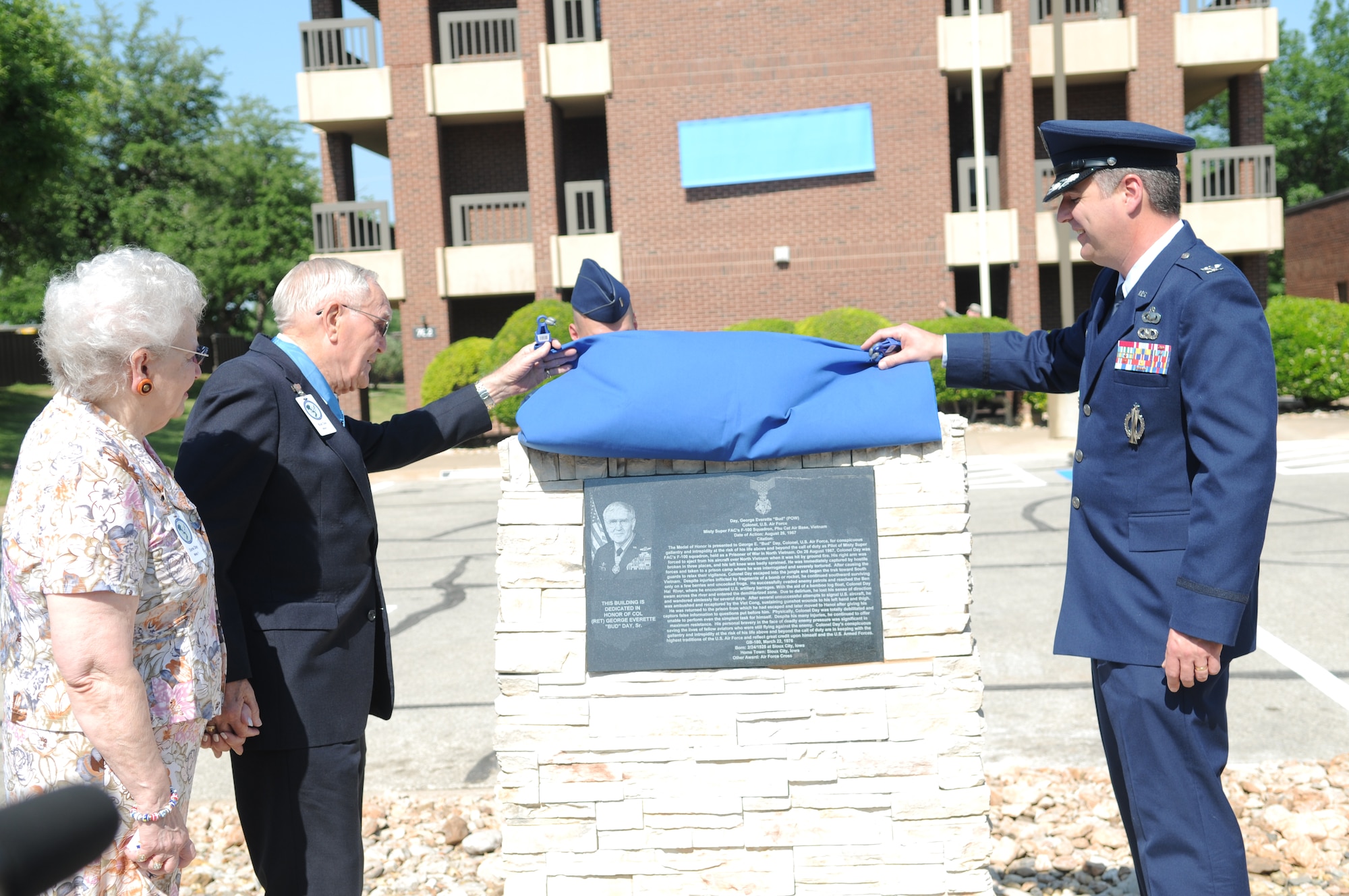GOODFELLOW AIR FORCE BASE, Texas – Retired Col. George E. “Bud” Day accompanied by his wife Doris, and Colonel Thomas Geary, 17th Training Wing commander, unveil the monolith in front of “Day Manor,” May 7, 2010. Two Visiting Officer Quarters were named in honor of retired Air Force Colonels George Day and Leo K. Thorsness, both of whom received the Medal of Honor for actions while serving in Vietnam. (U.S. Air Force photo/Airman 1st Class Clayton Lenhardt)
