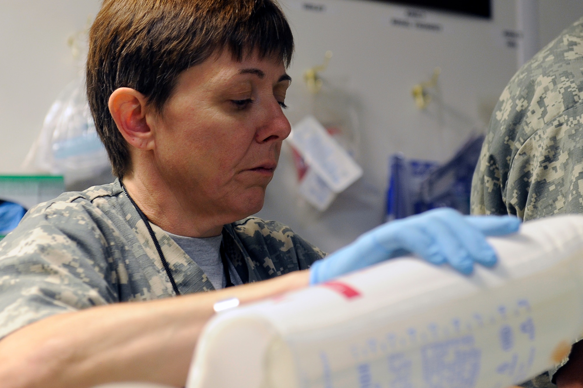 U.S. Air Force Maj. Cheryl Lockhart, 455th Expeditionary Medical Group/Task Force Medical East, sets up equipment for a patient after surgery at the Craig Joint Theater Hospital, Bagram Airfield, Afghanistan, May 5, 2010. Major Lockhart is deployed from Travis Air Force Base, Calif., and is from Buffalo, N.Y. (U.S. Air Force photo by/ Master Sgt. Jeromy K. Cross/released)