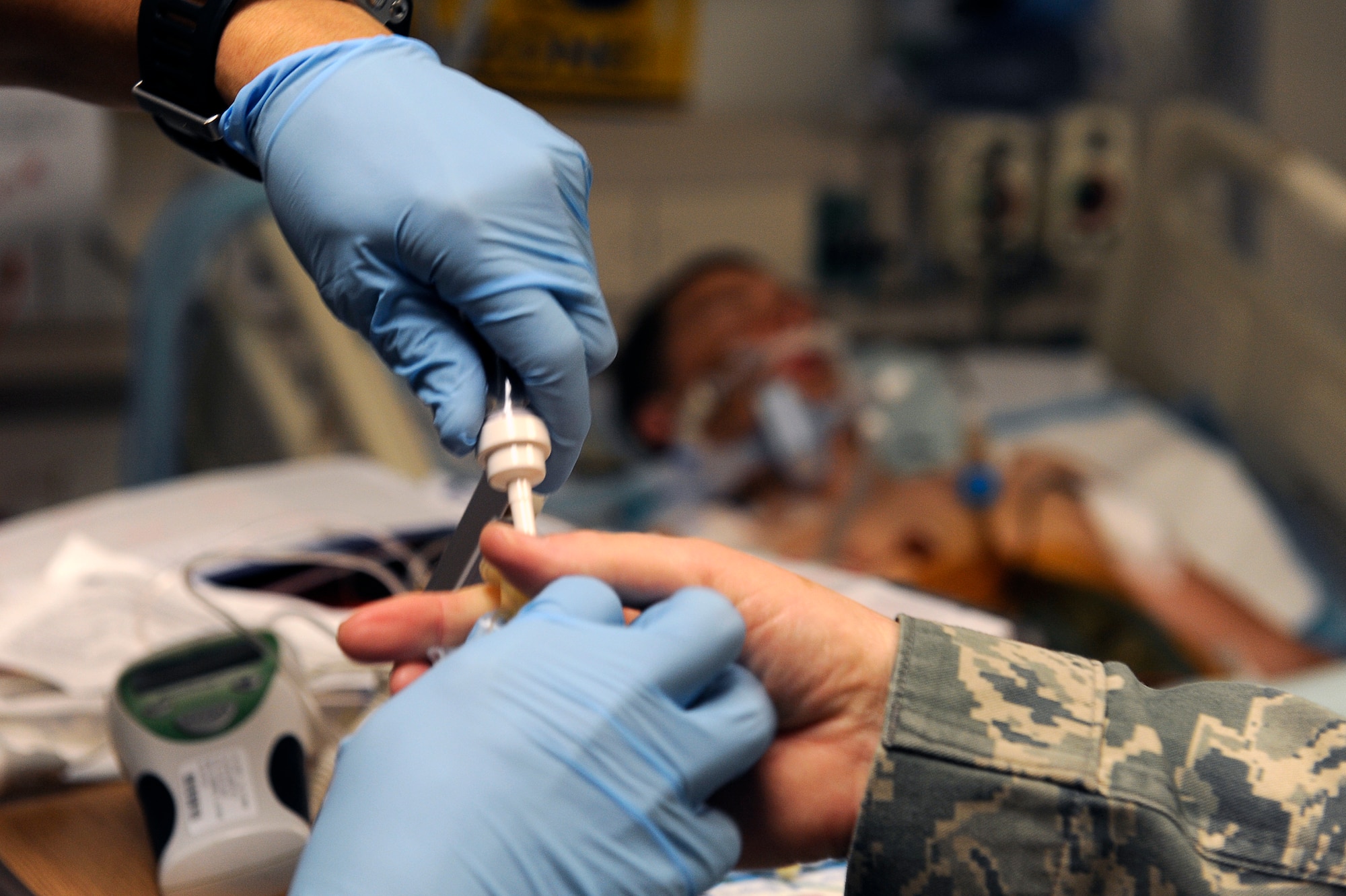 U.S. Air Force Airmen from the 455th Expeditionary Medical Group/Task Force Medical East prepare an IV in the intensive care unit at the Craig Joint Theater Hospital, Bagram Airfield, Afghanistan, May 5, 2010. (U.S. Air Force photo by/ Master Sgt. Jeromy K. Cross/released)