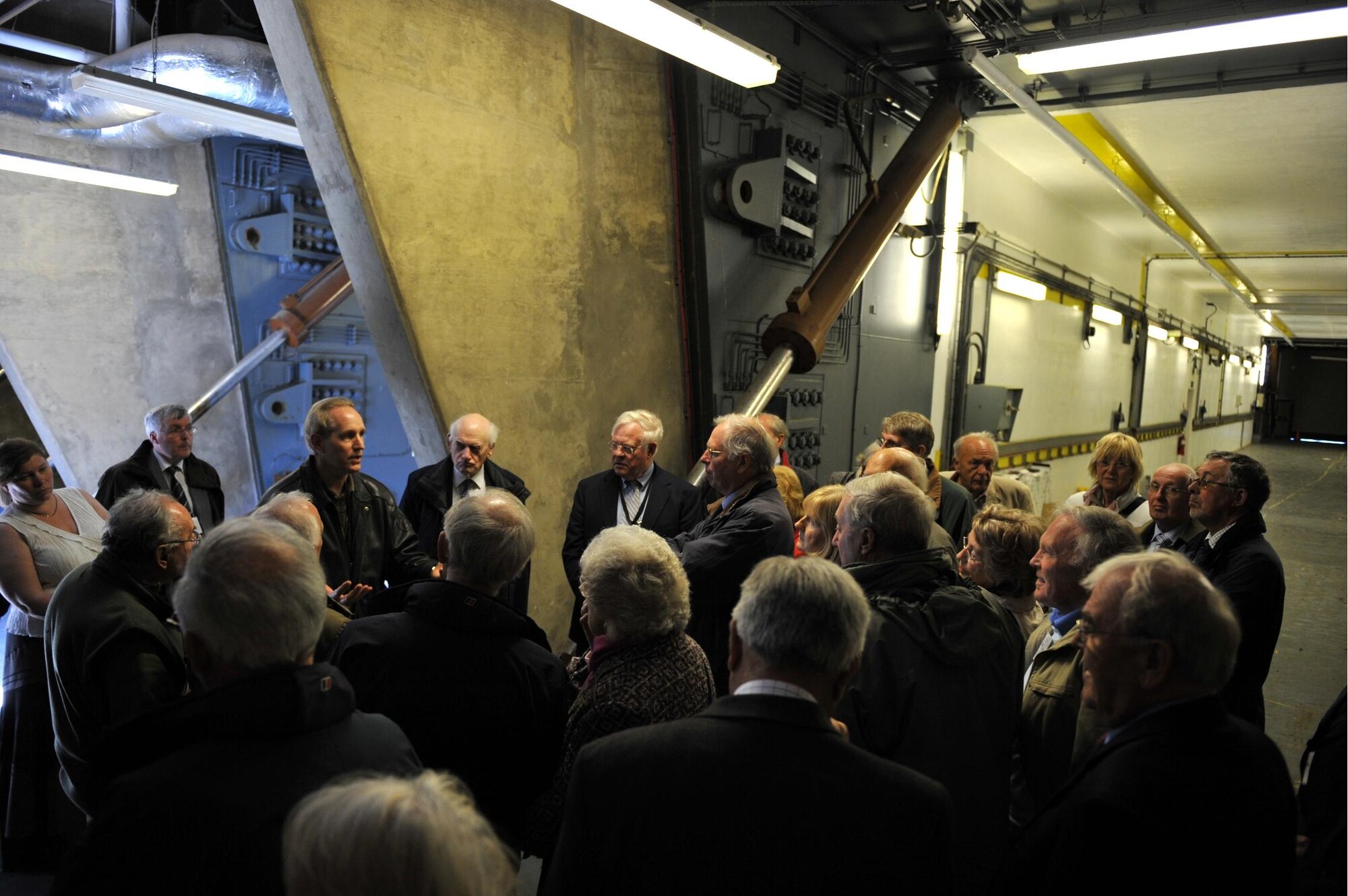 Mr. Jeff Bauer of the JIOCEUR Analytic Center Commander's Action Group briefs visiting members of the Peterborough, England PROBUS club on the workings of the now disused Cold War bunker which once sheltered missile Transporter Erector Launchers. (U.S. Air Force photo by Staff Sgt. Javier Cruz)