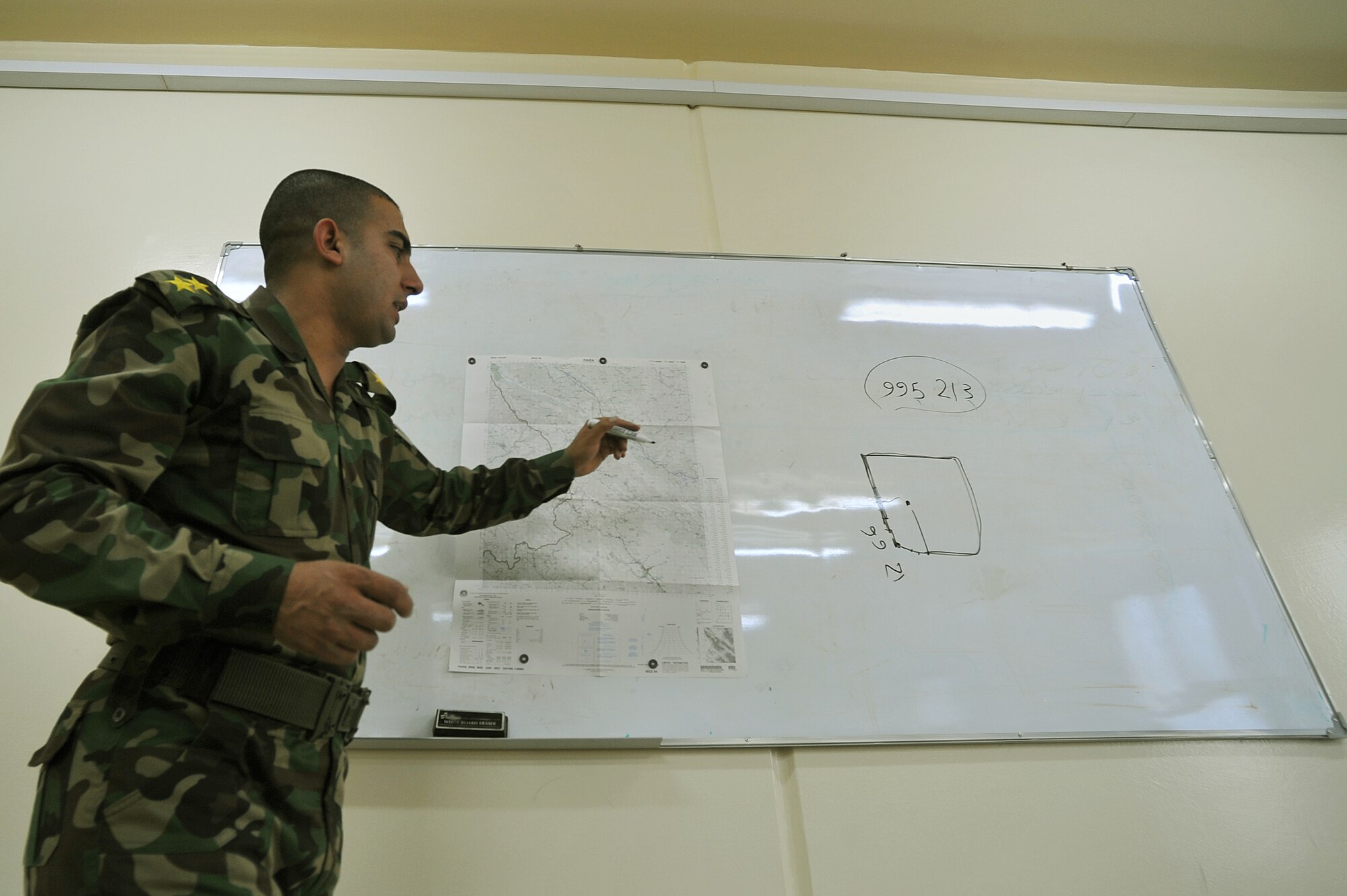 Iraqi Air Force Basic Training Instructor 1st Lt. Ammar Hamed instructs a land-navigation class at the Iraqi Air Force Training School in Camp Taji, Iraq, April 18, 2010. The Iraqi airmen volunteered to return to active duty through the rehire program by the Ministry of Defense.  (U.S. Air Force photo/Staff Sgt Quinton Russ/released)