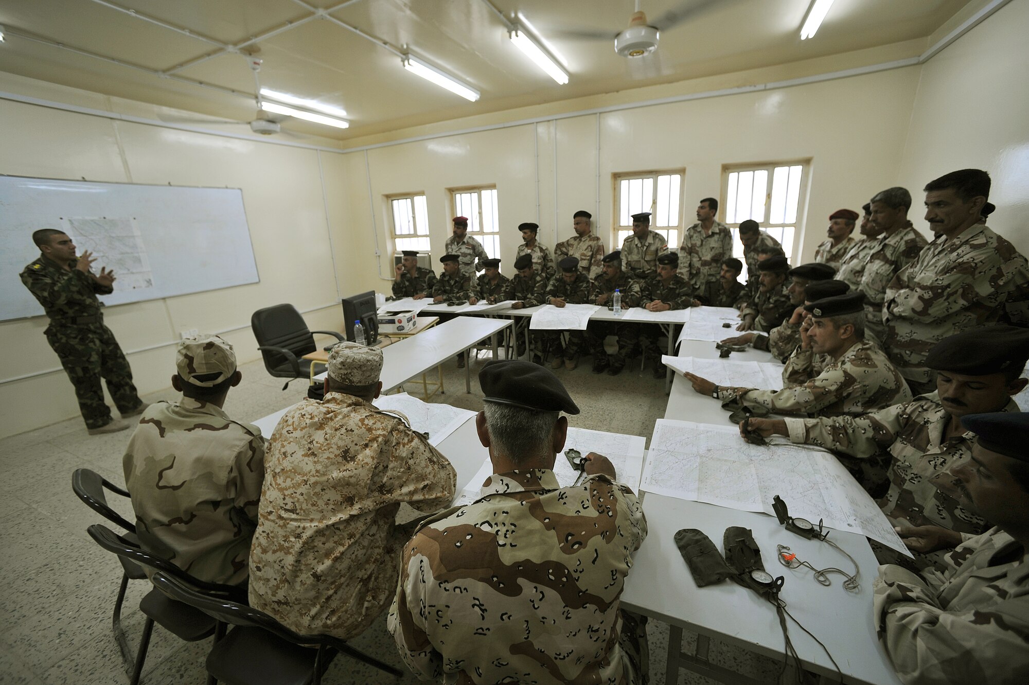Iraqi Air Force Basic Training Instructor 1st Lt. Ammar Hamed instructs a land-navigation class at the Iraqi Air Force Training School in Camp Taji, Iraq, April 18, 2010. The Iraqi airmen volunteered to return to active duty through the rehire program by the Ministry of Defense.  (U.S. Air Force photo/Staff Sgt Quinton Russ/released)