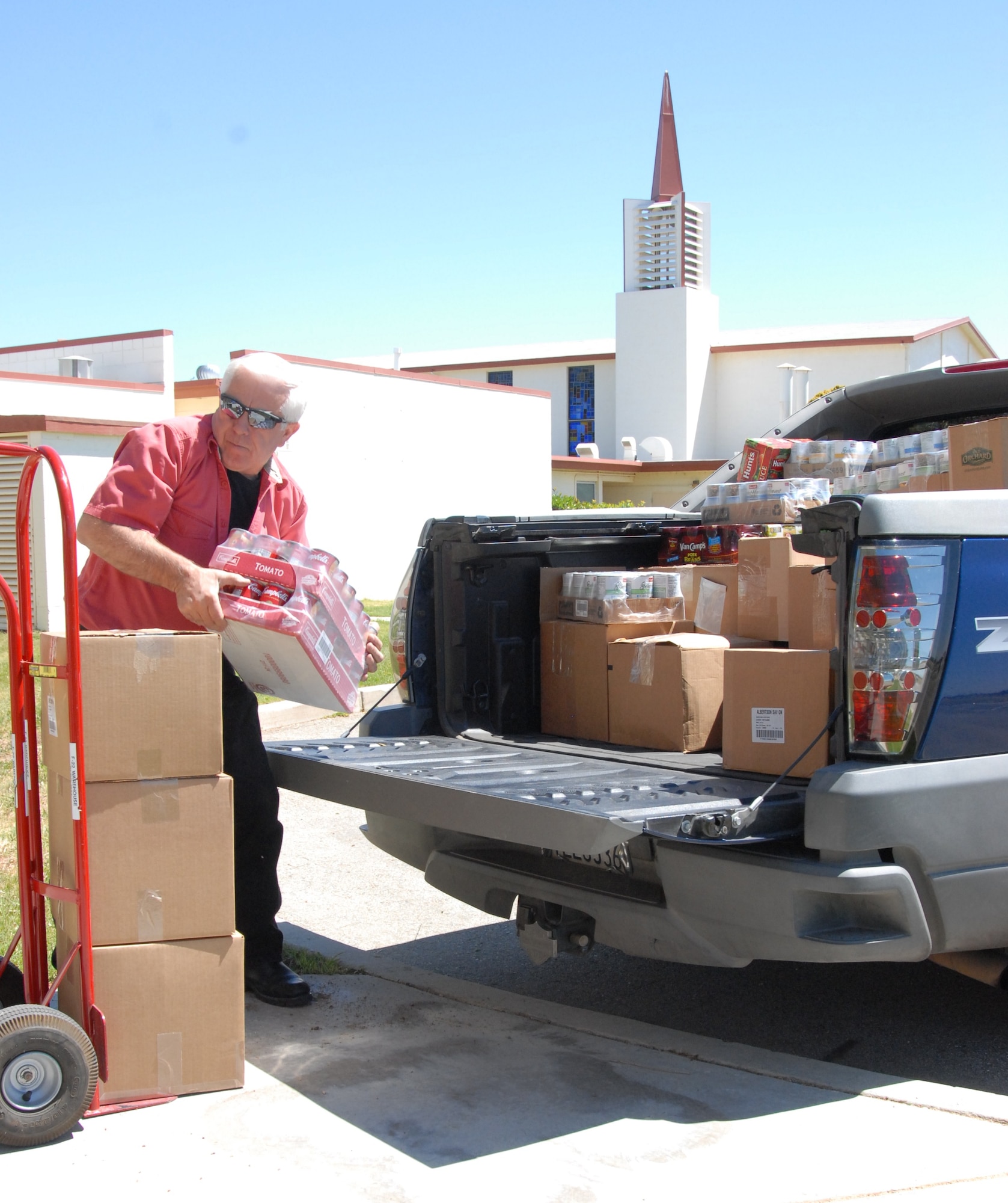Joe Masisak, Lockheed Martin, F-22 CTF, warehouse supervisor, unloads a base of canned soup at Edwards Main Community Chapel, May 7.  Lockheed employees spearheaded a donation drive this past month that collected more than 1,600 pounds of food.  The donation went to the chapel's food pantry program, which helps Airmen and their families when times are tough.  (Air Force photo by Kenji Thuloweit)