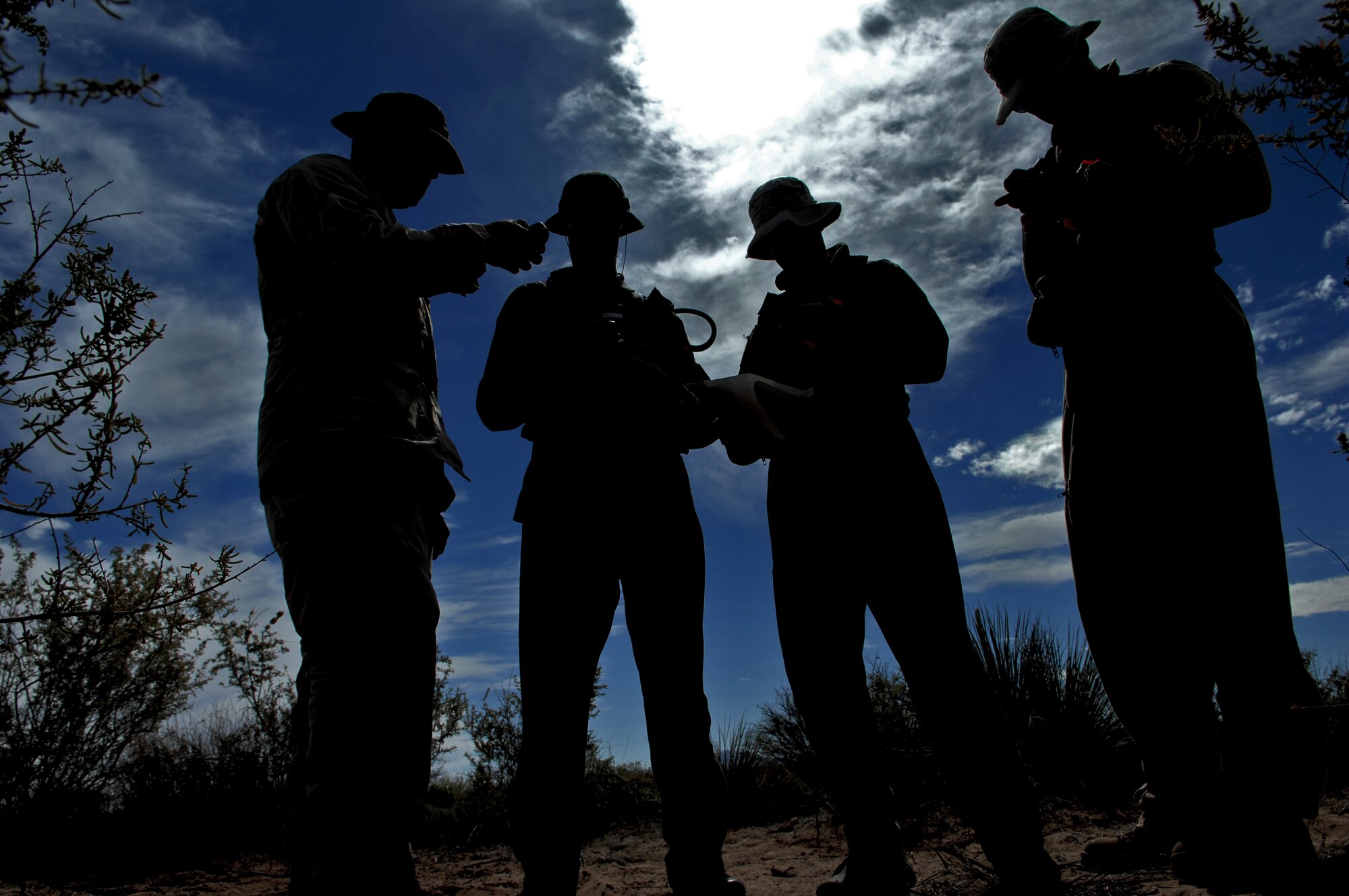 HOLLOMAN AIR FORCE BASE, N.M. -- A U.S. Air Force Survival, Evasion, Resistance and Escape specialist demonstrates how to use a Global Positioning System to Capts. Jeffrey Peterson, Bradley Young and Michael Thompson, 7th Fighter Squadron, May 5, 2010, during a SERE refresher training course. The SERE specialist demonstrates how to use equipment such as the GPS to familiarize the pilots with the gear they may have to use in a hostile situation.  Pilots and aircrew members are required to demonstrate competency in SERE techniques on a reoccurring basis. (U.S. Air Force photo by Airman 1st Class Joshua Turner / Released)