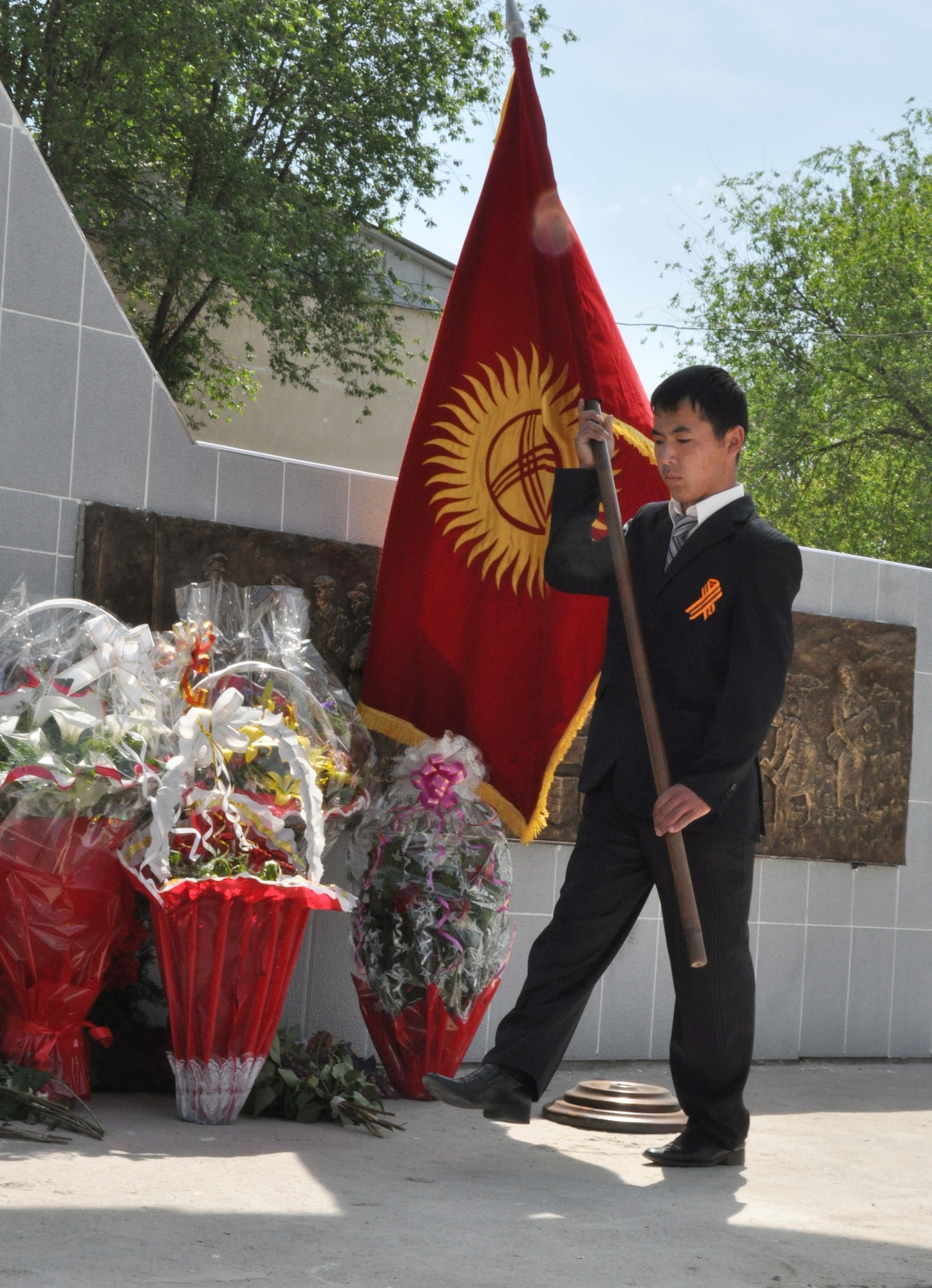 A Kyrgyz young man performs closing ceremonies during a Victory Day ceremony in Manas Village May 9, 2010. The mayor invited Col. Blaine Holt and Chief Master Sgt. James Dowell, the director and command chief for the Transit Center at Manas, to participate in the event, which honored living veterans and members of Manas Village who gave their lives during the Great Patriotic War (WWII). (U.S. Air Force photo/Staff Sgt. Carolyn Viss)