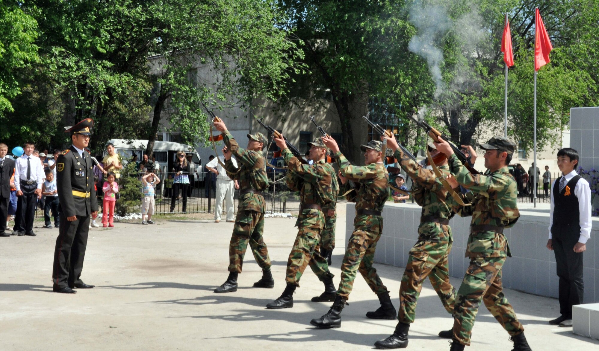 Kyrgyz military members fire a five-gun salute to Manas Village patriots who died during the Great Patriotic War (WWII) during a Victory Day ceremony in Manas Village, Kyrgyzstan, May 9, 2010. The mayor invited Col. Blaine Holt and Chief Master Sgt. James Dowell, the director and command chief for the Transit Center at Manas, to participate in the event. (U.S. Air Force photo/Staff Sgt. Carolyn Viss)