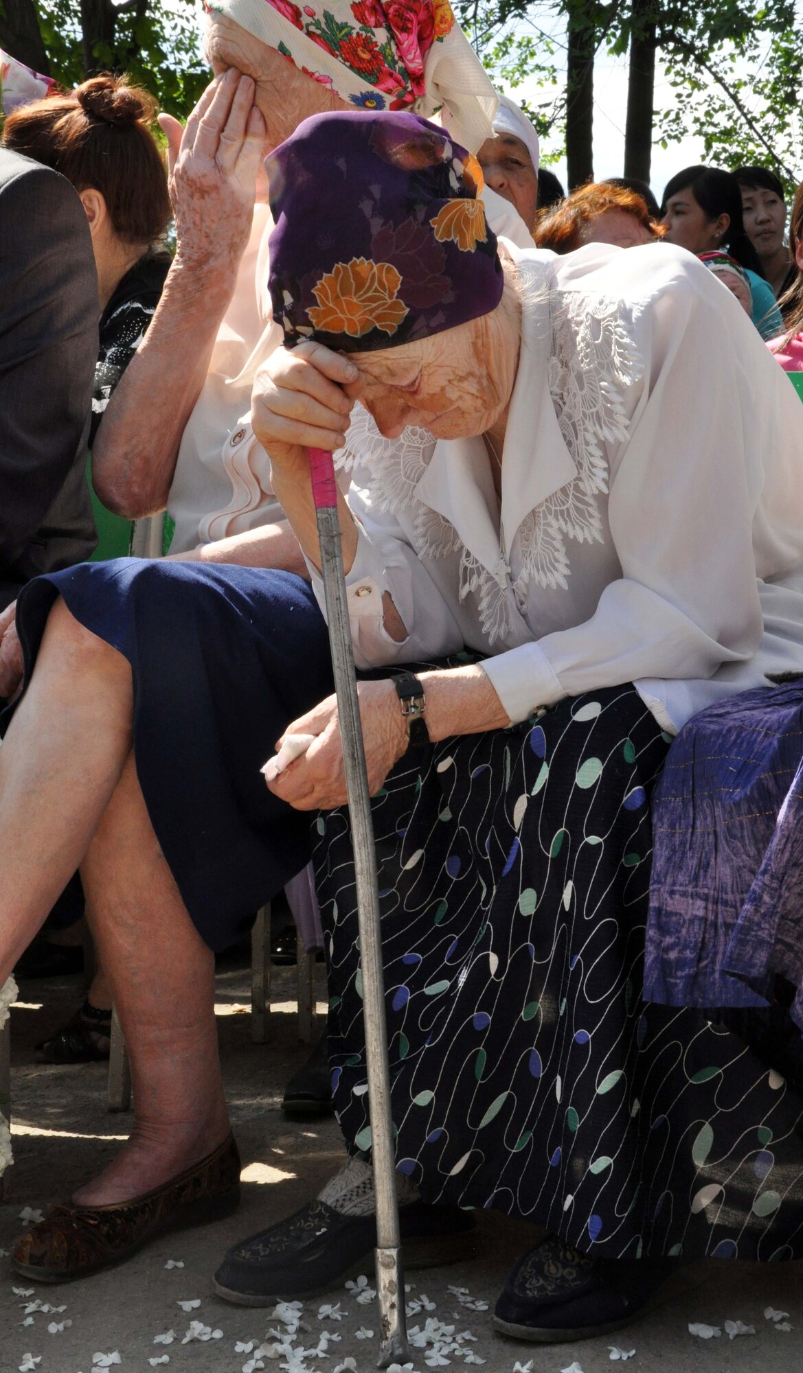 Two Kyrgyz women mourn the loss of their loved ones during a Victory Day ceremony marking the end of the Great Patriotic War (WWII) in Manas Village, Kyrgyzstan, May 9, 2010. During the event, a memorial wall was unveiled with about 50 names etched in stone of Manas patriots who died during the war, including these women?s loved ones. The mayor invited Col. Blaine Holt and Chief Master Sgt. James Dowell, the director and command chief for the Transit Center at Manas, to participate in the event. (U.S. Air Force photo/Staff Sgt. Carolyn Viss)