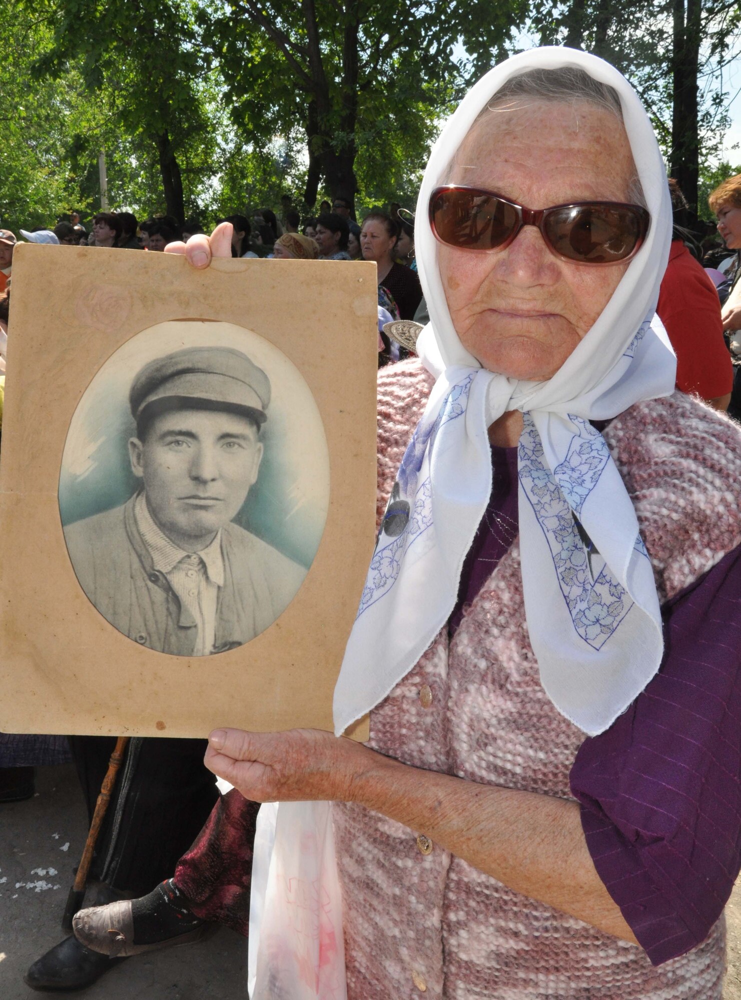 A Kyrgyz woman holds up the photo of a male relative of hers who died during the Great Patriotic War (WWII) during the Victory Day ceremony in Manas Village, Kyrgyzstan, May 9, 2010. The mayor invited Col. Blaine Holt and Chief Master Sgt. James Dowell, the director and command chief for the Transit Center at Manas, to participate in the celebration, which marked the end of the Nazi regime. During the event, a memorial wall was unveiled, with about 50 names etched in stone of Manas patriots who died during the war, including this woman?s loved one. (U.S. Air Force photo/Staff Sgt. Carolyn Viss)