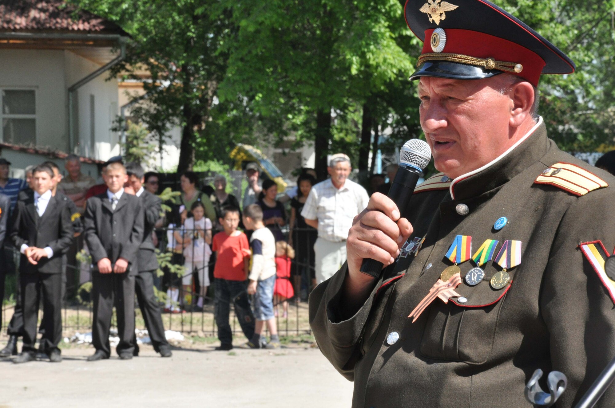A Kyrgyz military leader speaks to people of Manas Village, Kyrgyzstan, during a Victory Day ceremony May 9, 2010, celebrating the end of the Great Patriotic War (WWII) and the Nazi regime in 1945. During the event, four living veterans from Manas were honored and a memorial wall was unveiled with about 50 names etched in stone of village patriots who died during the war. (U.S. Air Force photo/Staff Sgt. Carolyn Viss)