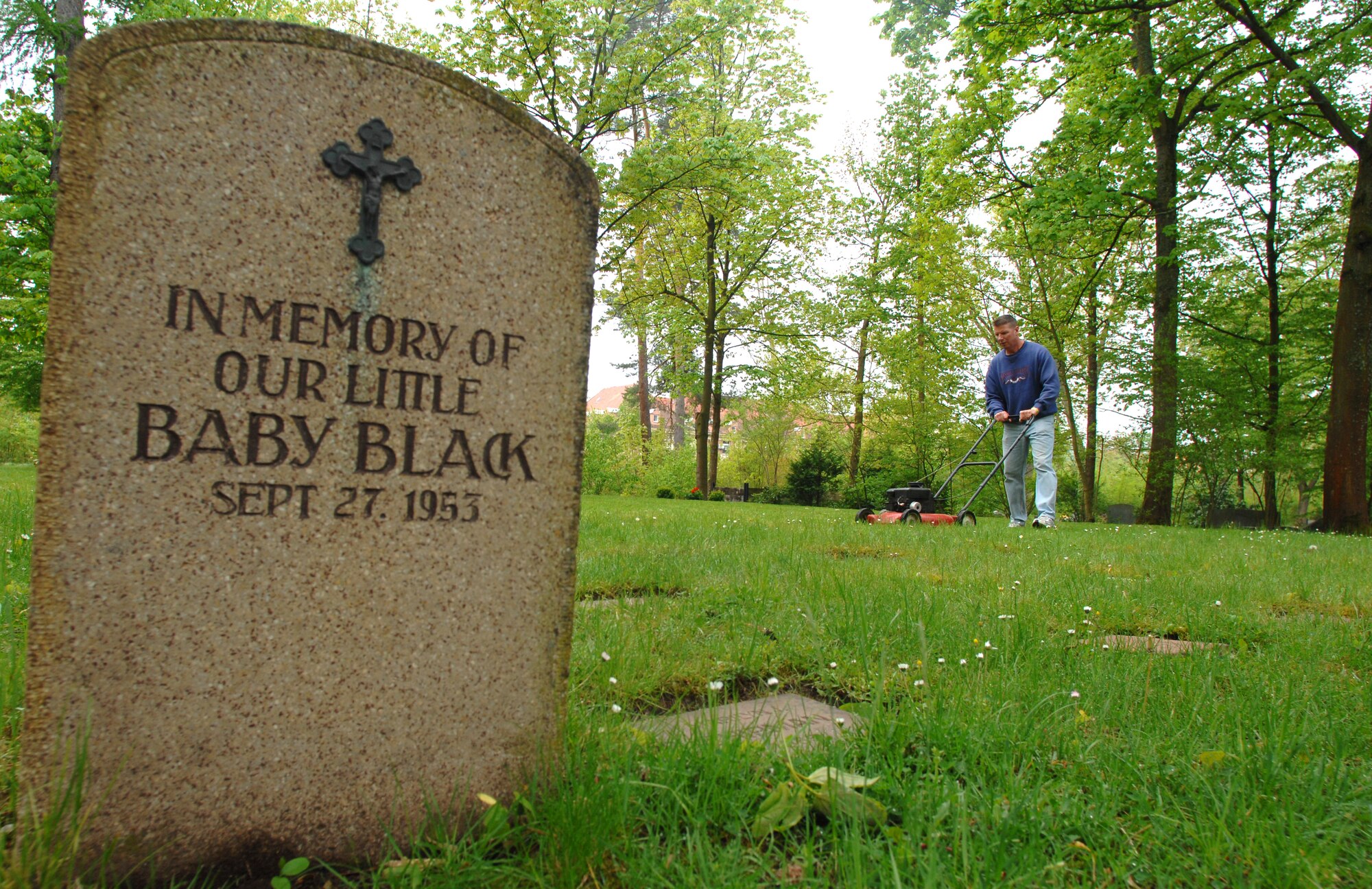 U.S. Air Force Chief Master Sgt. Ed Rosemeier, 86th Medical Group superintendent  Squadron mows the grounds of the Kaiserslautern Kindergraves Memorial Cemetery in preparation for a yearly remembrance ceremony.The 2010 Kindergraves memorial ceremony will take place May 15 at 10 a.m. at the U.S. Army Daenner Kaserne Chapel. (Air Force photo by Tech. Sgt. Michael Voss)