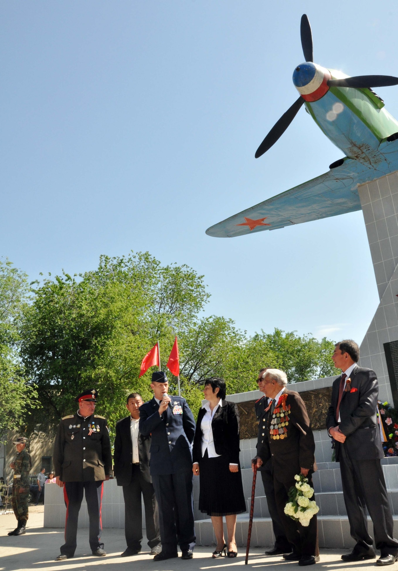 U.S. Air Force Col. Blaine Holt, the director of the Transit Center at Manas, speaks to the people of Manas Village, Kyrgyzstan, during a Victory Day ceremony May 9, 2010, celebrating the end of the Great Patriotic War (WWII) and the Nazi regime in 1945. Colonel Holt gave his speech partly in the Kyrgyz language. During the event, four living veterans from Manas were honored, and a memorial wall was unveiled with about 50 names etched in stone of village patriots who died during the war. (U.S. Air Force photo/Staff Sgt. Carolyn Viss)