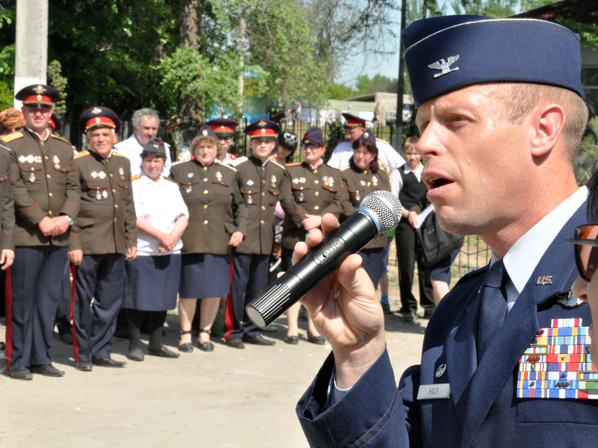 U.S. Air Force Col. Blaine Holt, the director of the Transit Center at Manas, speaks to the people of Manas Village, Kyrgyzstan, during a Victory Day ceremony May 9, 2010, celebrating the end of the Great Patriotic War (WWII) and the Nazi regime in 1945. Colonel Holt gave his speech partly in the Kyrgyz language. During the event, four living veterans from Manas were honored, and a memorial wall was unveiled with about 50 names etched in stone of village patriots who died during the war. (U.S. Air Force photo/Staff Sgt. Carolyn Viss)