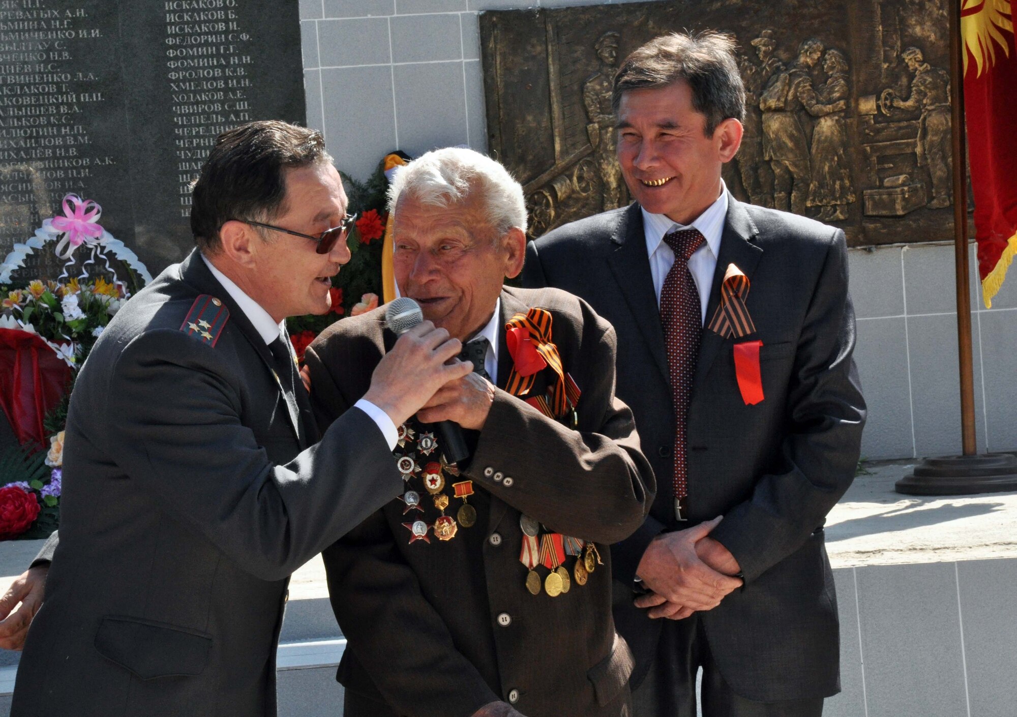 The Mayor of Manas, Mr. Beshimbaev Kabylbek (left), honors a highly-decorated veteran of the Great Patriotic War (WWII) during a Victory Day ceremony in Manas Village, Kyrgyzstan, May 9, 2010. This day marks the end of WWII and the Nazi regime in 1945. During the event, four living veterans from Manas were honored, and a memorial wall was unveiled with about 50 names etched in stone of village patriots who died during the war. (U.S. Air Force photo/Staff Sgt. Carolyn Viss)