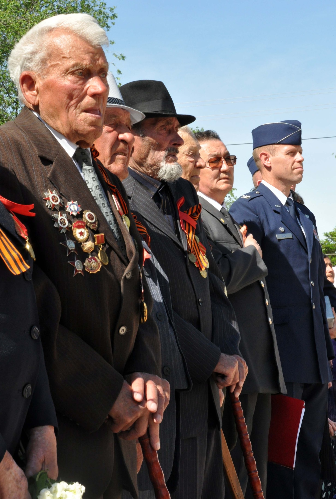 Col. Blaine Holt, the director of the Transit Center of Manas, Kyrgyzstan, honors the patriots who died in the Great Patriotic War (WWII) during a Victory Day ceremony in Manas Village May 9, 2010. During the event, four living veterans from Manas were honored, and a memorial wall was unveiled with about 50 names etched in stone of village patriots who died during the war. (U.S. Air Force photo/Staff Sgt. Carolyn Viss)