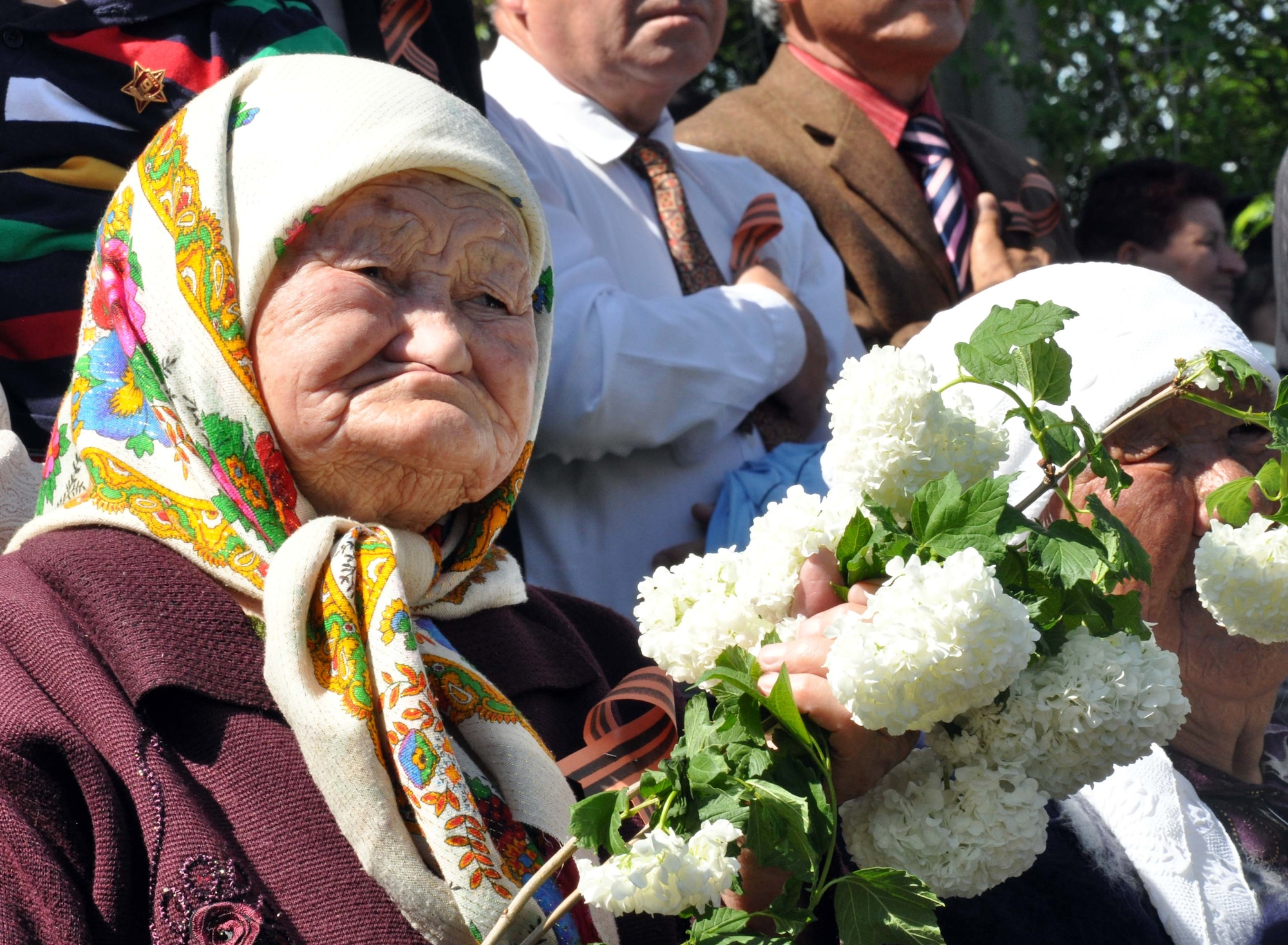 A Kyrgyz babushka (Russian for older, grandmotherly, well-respected lady) watches the Victory Day ceremony in Manas Village, Kyrgyzstan, May 9, 2010. The mayor invited Col. Blaine Holt and Chief Master Sgt. James Dowell, the director and command chief for the Transit Center at Manas, to participate in the celebration of the end of the Nazi regime. During the event, a memorial wall was unveiled, with about 50 names etched in stone of Manas patriots who died during the war. (U.S. Air Force photo/Staff Sgt. Carolyn Viss)