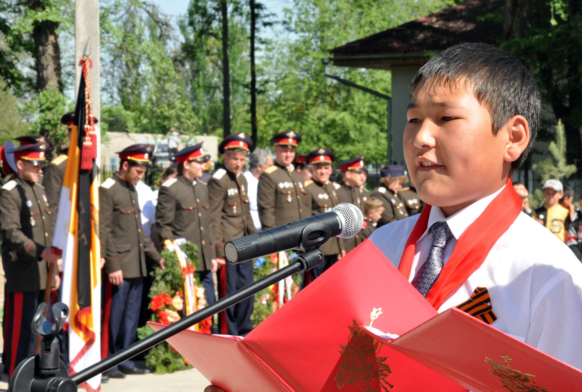 A Kyrgyz boy gives the opening proclamation during a Victory Day ceremony in Manas Village, Kyrgyzstan, May 9, 2010. The mayor invited Col. Blaine Holt and Chief Master Sgt. James Dowell, the director and command chief for the Transit Center at Manas, to participate in the celebration of the end of the Nazi regime. During the event, a memorial wall was unveiled, with about 50 names etched in stone of Manas patriots who died during the war. (U.S. Air Force photo/Staff Sgt. Carolyn Viss)