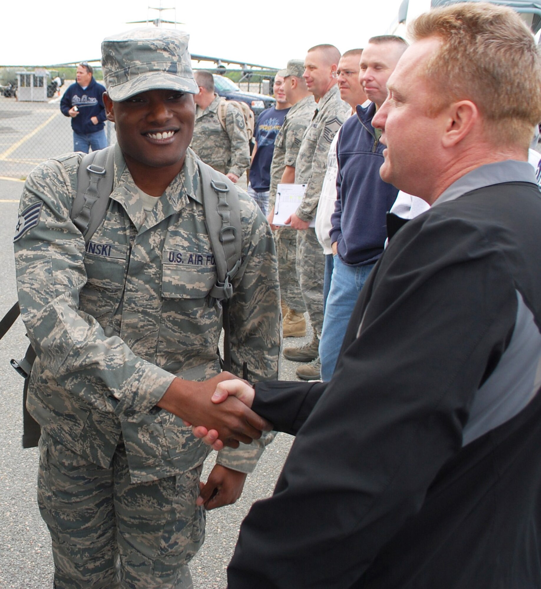 Staff Sgt. Devin Kaminski, shakes hands with his first sergeant, Senior Master Sgt. Michael Wysocki, as he gets ready to board a bus from Westover Air Reserve Base to begin his deployment. Kaminski is deployed to Afghanistan from Westover until the fall. 
