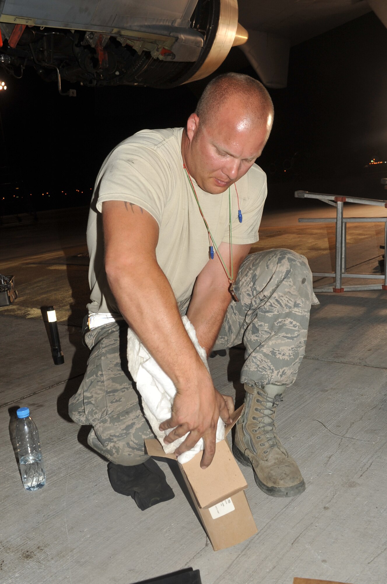 Staff Sgt. Michael Latiolais, KC-10 Extender aerospace maintenance journeyman with the 380th Expeditionary Aircraft Maintenance Squadron's Extender aircraft maintenance unit, works on a KC-10 engine in the evening hours of May 1, 2010, at a non-disclosed base in Southwest Asia.  Sergeant Latiolais is deployed from the 660th Aircraft Maintenance Squadron, 60th Air Mobility Wing, Travis Air Force Base, Calif. His hometown is Saint Martinville, La. (U.S. Air Force Photo/Master Sgt. Scott T. Sturkol/Released)