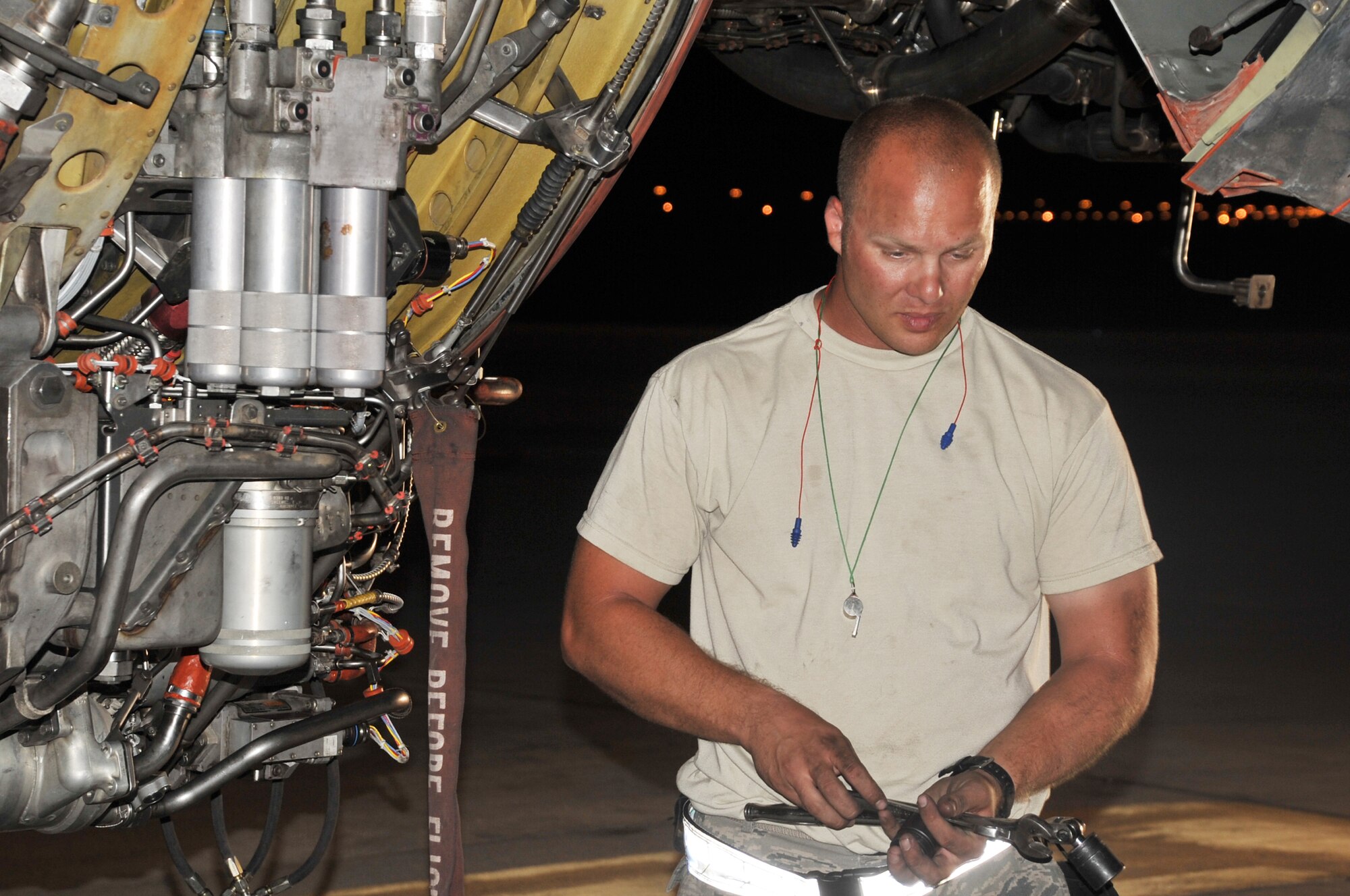 Staff Sgt. Michael Latiolais, KC-10 Extender aerospace maintenance journeyman with the 380th Expeditionary Aircraft Maintenance Squadron's Extender aircraft maintenance unit, works on a KC-10 engine in the evening hours of May 1, 2010, at a non-disclosed base in Southwest Asia.  Sergeant Latiolais is deployed from the 660th Aircraft Maintenance Squadron, 60th Air Mobility Wing, Travis Air Force Base, Calif. His hometown is Saint Martinville, La. (U.S. Air Force Photo/Master Sgt. Scott T. Sturkol/Released)