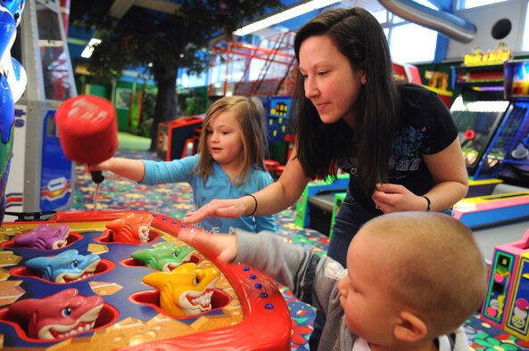 (From left to right) Jada, Amanda and Niko Saldukas, wife and children of Senior Airman Scott Saldukas play a game at the 'Kid Zone' on Pulaski Barraks, Germany, May 4, 2009. The 'Kid Zone' reopened April 17 after a six-month renovation process to modernize the center.