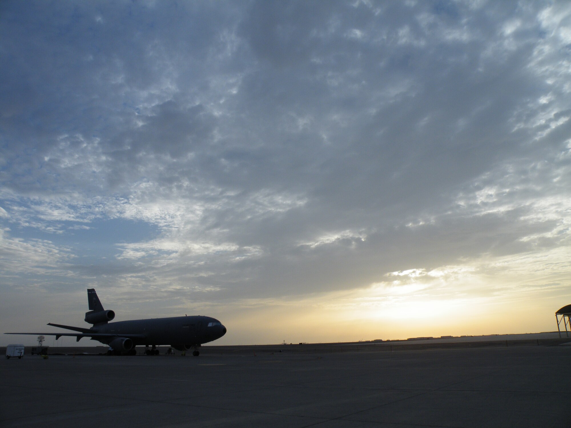 A KC-10 Extender from the 908th Expeditionary Air Refueling Squadron is silouetted as the sun sets during operations for the 380th Air Expeditionary Wing on the flightline May 6, 2010, at a non-disclosed base in Southwest Asia. In the first three months of 2010, Airmen supporting the KC-10 deployed air refueling mission in the U.S. Central Command area of responsibility flew more than 1,000 sorties offl-loading more than 108 million pounds of fuel to more than 6,600 aircraft in support of combat operations. The 908th EARS, as part of the 380th Air Expeditionary Wing, support operations Iraqi Freedom and Enduring Freedom and the Combined Joint Task Force-Horn of Africa. (U.S. Air Force Photo/Staff Sgt. Nathan D. Delgado/Released)