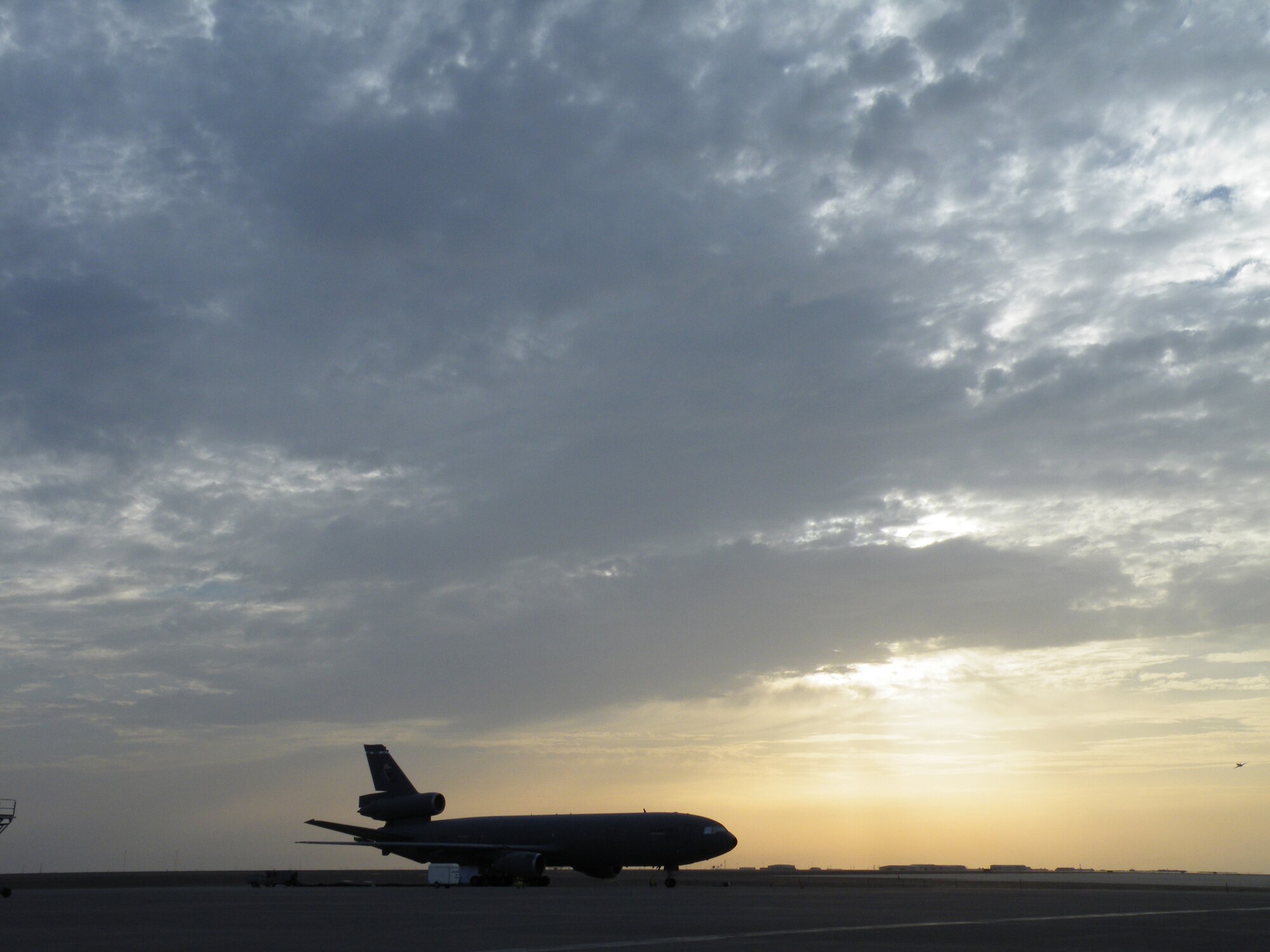 A KC-10 Extender from the 908th Expeditionary Air Refueling Squadron is silouetted as the sun sets during operations for the 380th Air Expeditionary Wing on the flightline May 6, 2010, at a non-disclosed base in Southwest Asia. In the first three months of 2010, Airmen supporting the KC-10 deployed air refueling mission in the U.S. Central Command area of responsibility flew more than 1,000 sorties offl-loading more than 108 million pounds of fuel to more than 6,600 aircraft in support of combat operations. The 908th EARS, as part of the 380th Air Expeditionary Wing, support operations Iraqi Freedom and Enduring Freedom and the Combined Joint Task Force-Horn of Africa. (U.S. Air Force Photo/Staff Sgt. Nathan D. Delgado/Released)