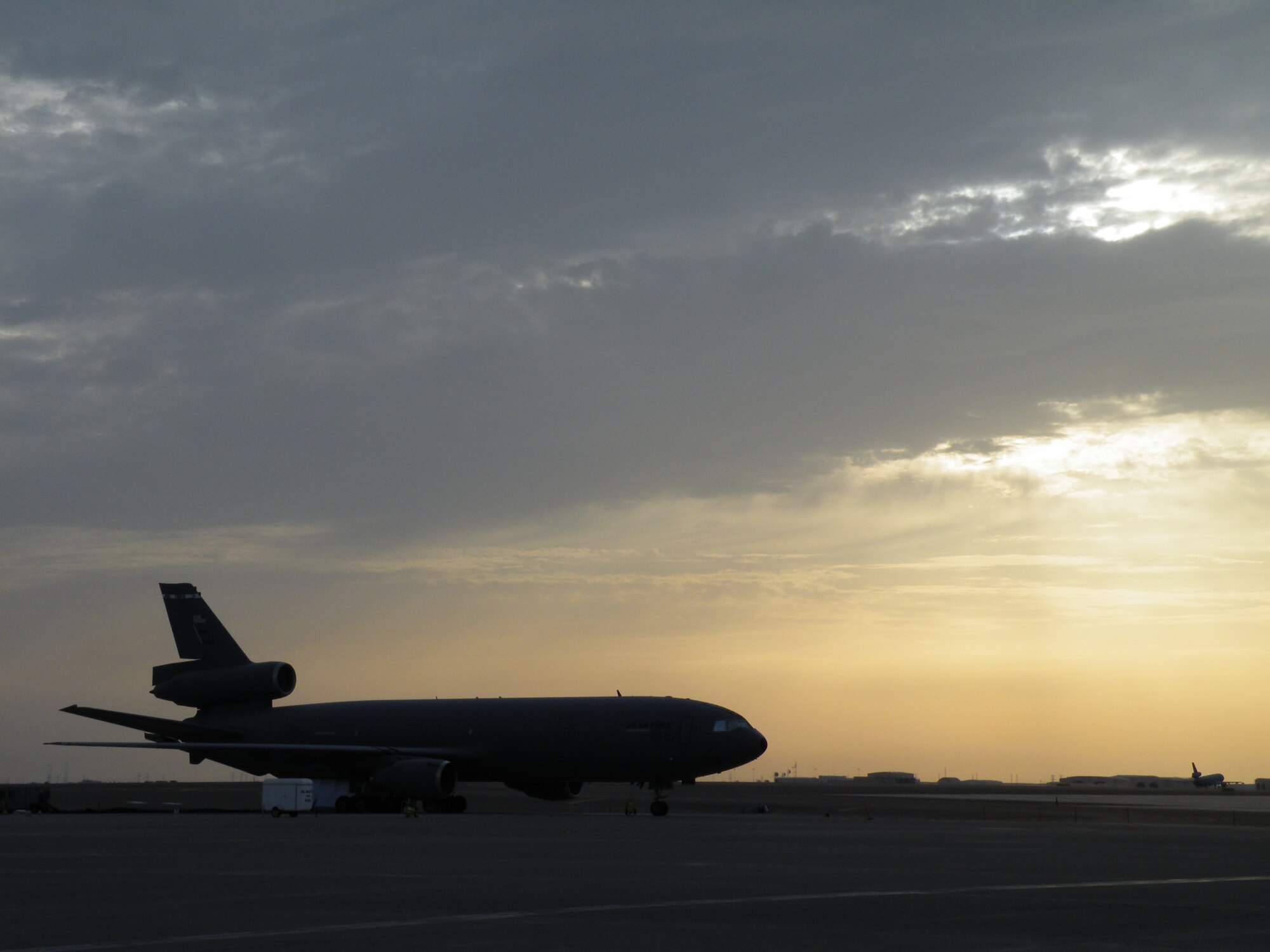 A KC-10 Extender from the 908th Expeditionary Air Refueling Squadron is silouetted as the sun sets during operations for the 380th Air Expeditionary Wing on the flightline May 6, 2010, at a non-disclosed base in Southwest Asia. In the first three months of 2010, Airmen supporting the KC-10 deployed air refueling mission in the U.S. Central Command area of responsibility flew more than 1,000 sorties offl-loading more than 108 million pounds of fuel to more than 6,600 aircraft in support of combat operations. The 908th EARS, as part of the 380th Air Expeditionary Wing, support operations Iraqi Freedom and Enduring Freedom and the Combined Joint Task Force-Horn of Africa. (U.S. Air Force Photo/Staff Sgt. Nathan D. Delgado/Released)