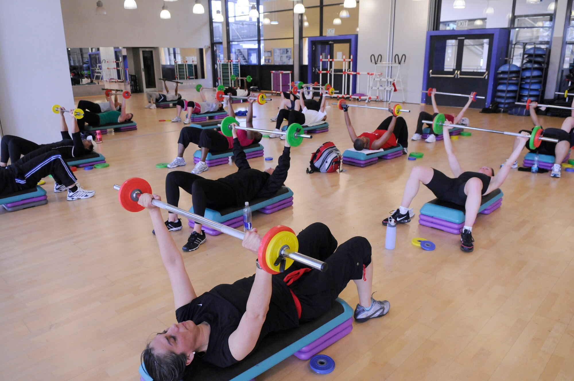 Military members and spouses participate in a strength class during an aerobathon, South Side Fitness Center, Ramstein Air Base, Germany, May 8, 2010. The aerobathon was held at the fitness center in part of May Fitness Month. (U.S. Air Force photo by Airman 1st Class Brittany Perry)