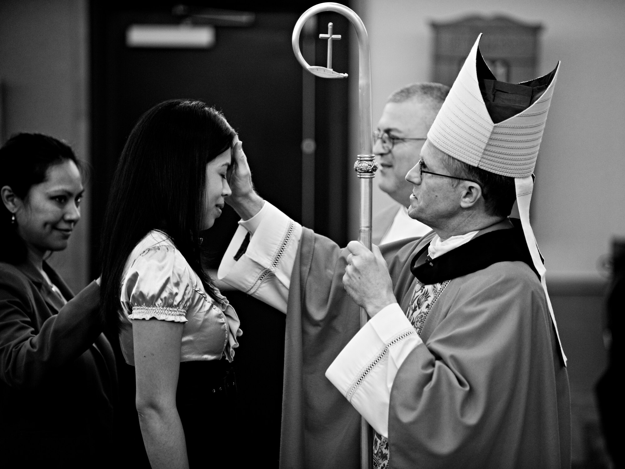 MISAWA AIR BASE, Japan -- Archbishop Timothy Broglio, archbishop for U.S. military services, anoints Chrystin Aguero during Misawa's 2010 Confirmation Mass May 6 at the base chapel. Eight individuals from Misawa embarked the next stage of their spiritual journey during the confirmation, an event that took one year's worth of preparation. Chrystin is the wife of U.S. Navy Petty Officer 2nd Class Ryan Aguero, Naval Air Facility Misawa. (U.S. Air Force photo/Senior Airman Jamal D. Sutter)