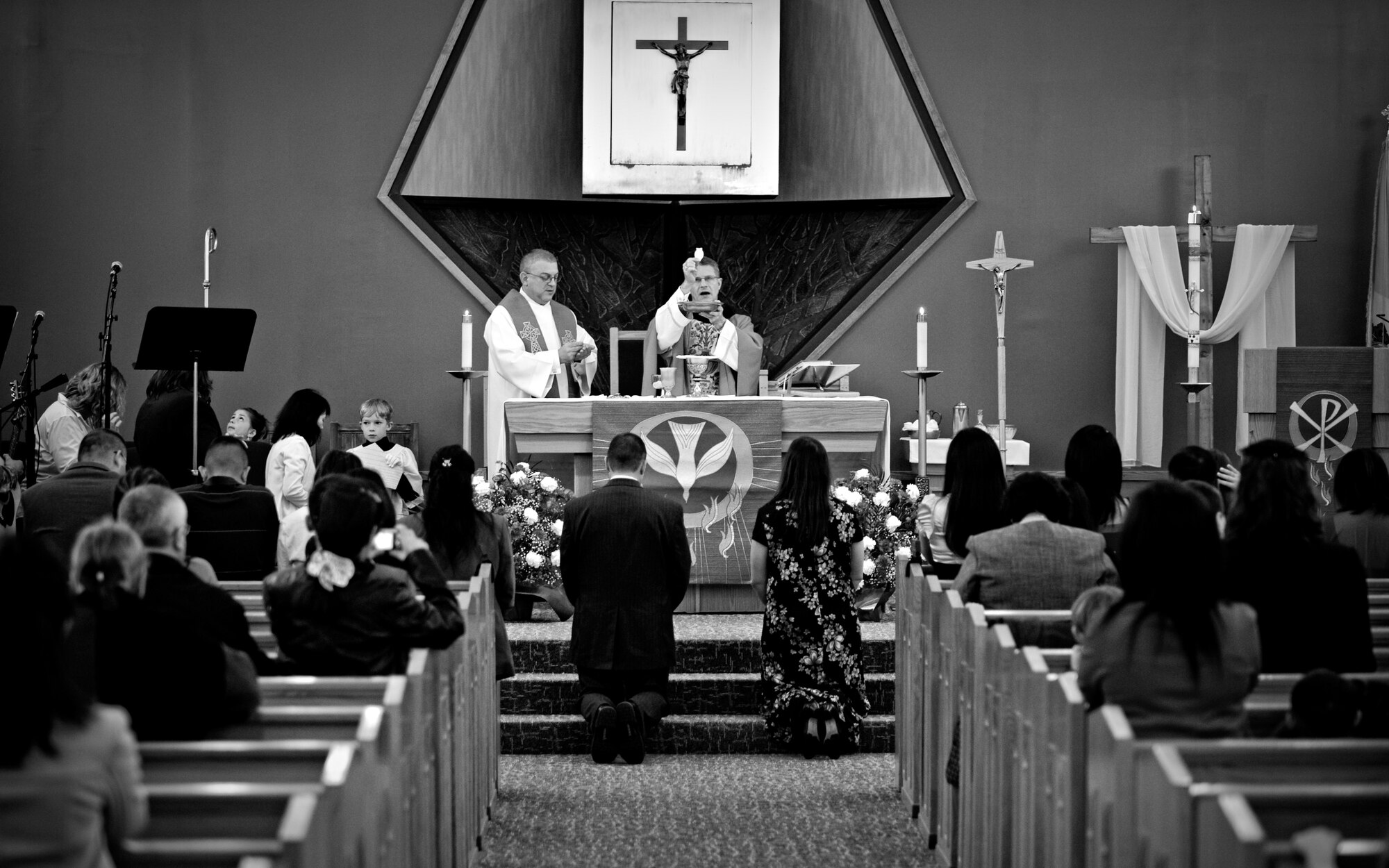 MISAWA AIR BASE, Japan -- Archbishop Timothy Broglio, archbishop for U.S. military services, Chaplain (Capt.) Dominic Vitaliano, Catholic chaplain for Misawa Air Base, and members of mass take part in a leading communion during Misawa's 2010 Confirmation Mass May 6 at the base chapel. Confirmation is the final sacrament Catholics pass in the process of their religious journey. (U.S. Air Force photo/Senior Airman Jamal D. Sutter)