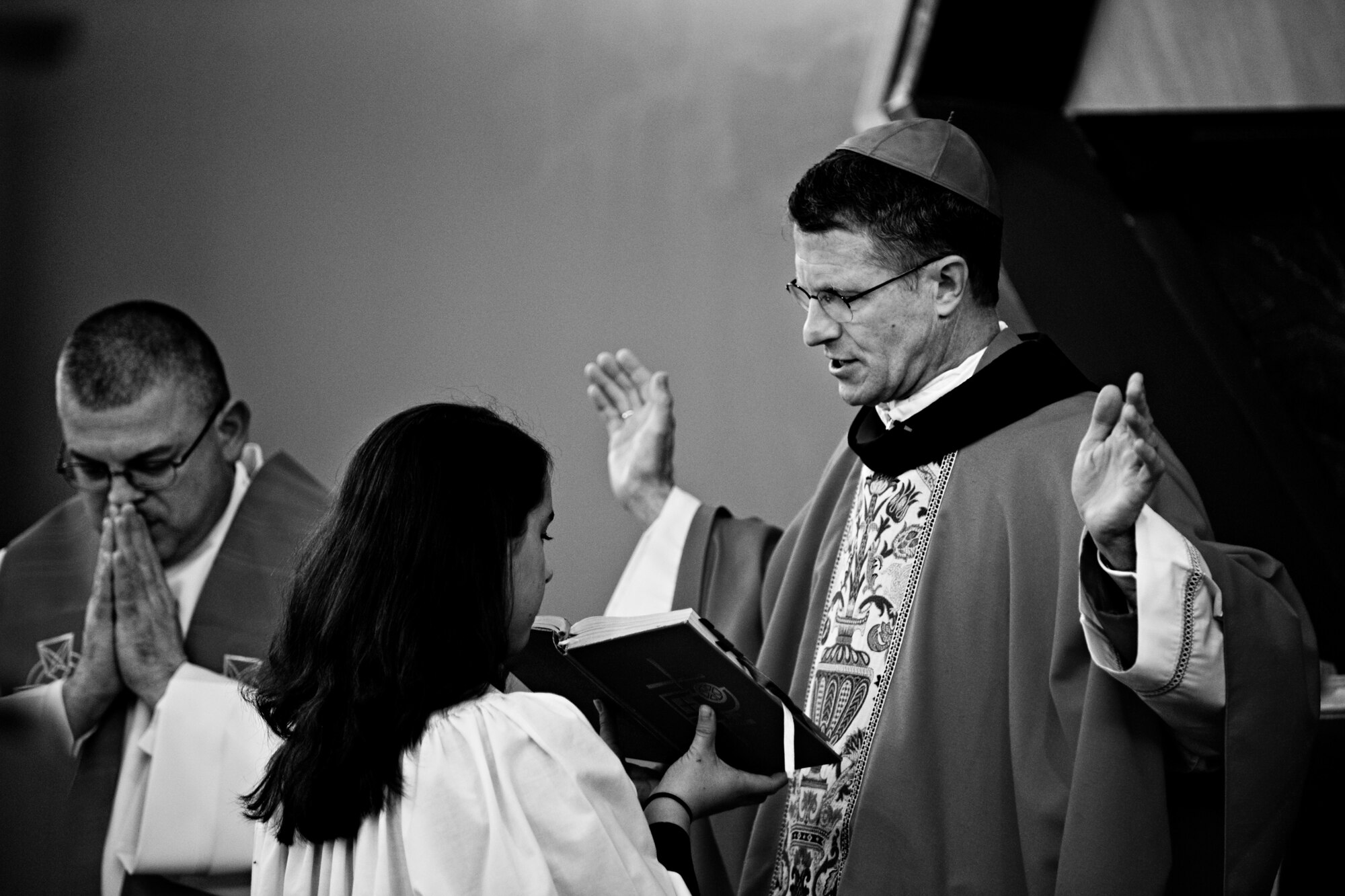 MISAWA AIR BASE, Japan -- Archbishop Timothy Broglio, archbishop for U.S. military services, leads a closing prayer with assistance from Monica Cronin during Misawa's 2010 Confirmation Mass May 6 at the base chapel. Archbishop Broglio visited Misawa to administer the confirmation of eight individuals. Monica is the daughter of Senior Master Sgt. John Cronin, 35th Fighter Wing superintendent of medical inspections. (U.S. Air Force photo/Senior Airman Jamal D. Sutter)