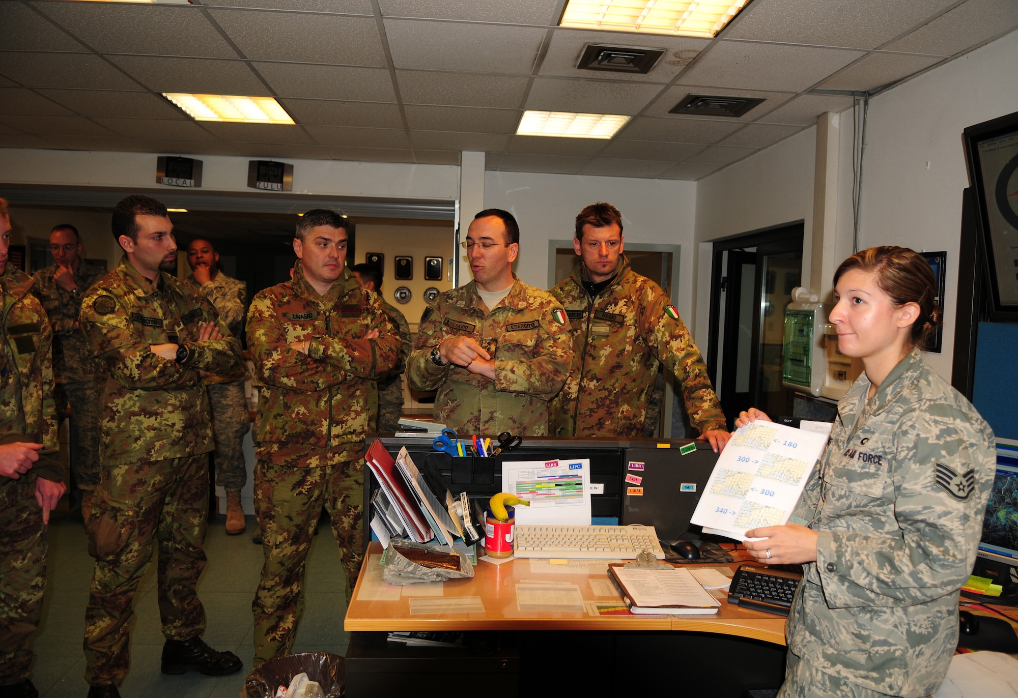 Staff Sgt. Eryn Buckner, 31st Operational Support Squadron weather forecaster, explains how weather conditions are logged and tracked during Project Partnership on May 5. The G3 Southern Europe Task Force avalanche forecasters came to Aviano for a day to get an idea on how the U.S. Air Force does business. (U.S. Air Force photo/ Staff Sgt. Taylor L. Marr)