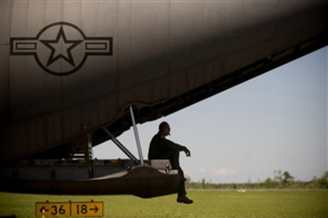 U.S. Air Force Master Sgt. John Molino, a C-130 Hercules aircraft aerial spray operator loadmaster from the 910th Airlift Wing, waits for the weather to clear at Stennis International Airport in Kiln, Miss., in order to start engines on the C-130 for a chemical-dispersing mission on May 4, 2010.  Members of the 910th Airlift Wing are in Mississippi to assist with the Deepwater Horizon oil spill.  The 910th Airlift Wing specializes in aerial spray and is the Department of Defense’s only large-area fixed-wing aerial spray unit.  
