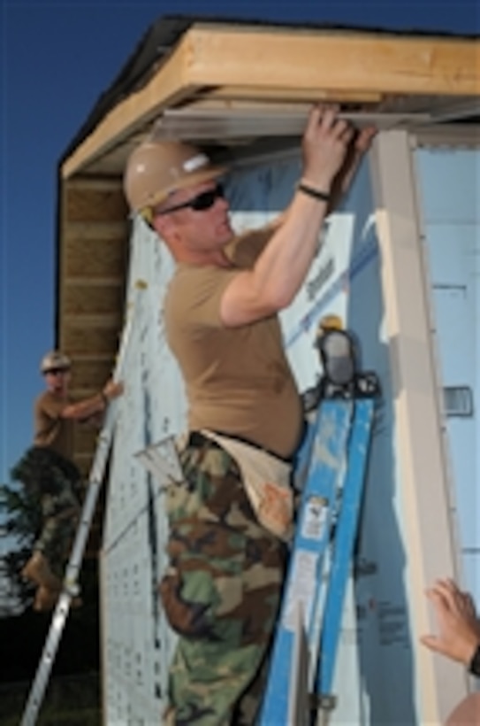 U.S. Navy Seabees assigned to the Naval Mobile Construction Battalion 24 install siding at a Habitat for Humanity construction during a Birmingham Navy Week event in Birmingham, Ala., on May 4, 2010.  Birmingham Navy Week is one of 20 Navy Weeks planned across the United States in 2010.  