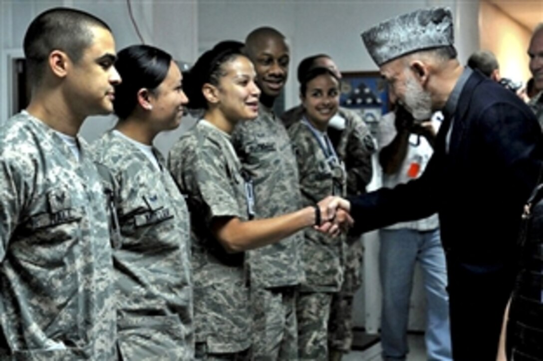 Afghanistan President Hamid Karzai shakes hands with U.S. airmen at Heath N. Craig Joint Theater Hospital on Bagram Airfield, Afghanistan, May 8, 2010. Karzai was scheduled to travel to the United States to meet with President Barack Obama.