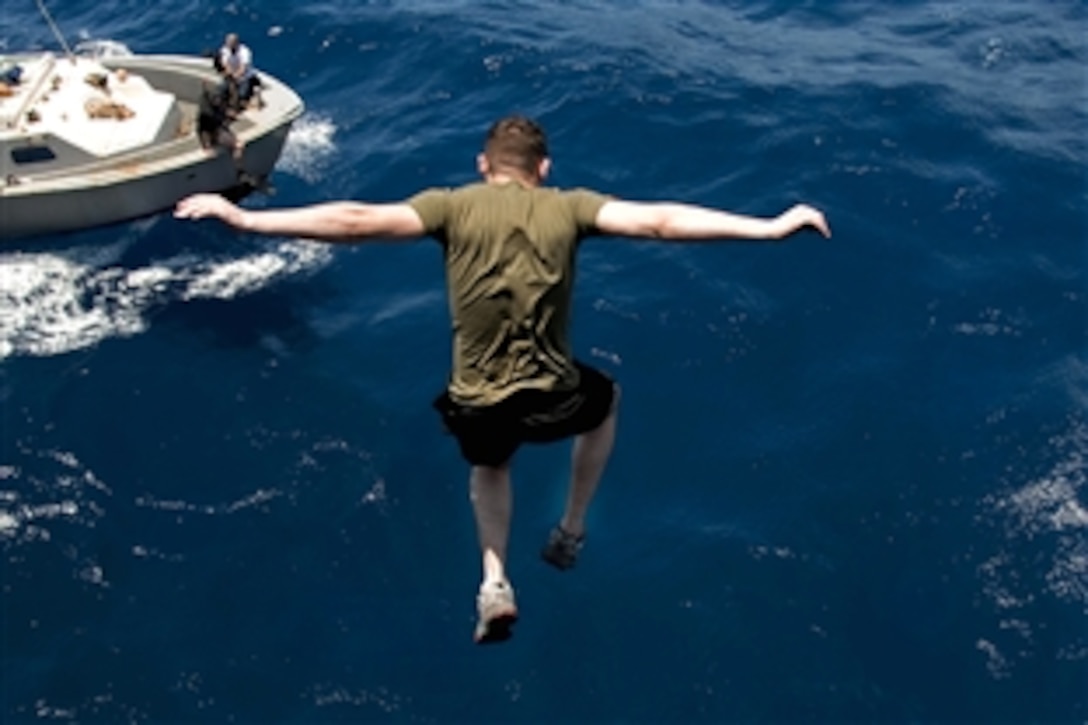 A U.S. Marine jumps off an aircraft elevator aboard the amphibious assault ship USS Nassau
during a swim call in the 5th Fleet area of responsibility, May 1, 2010. The Nassau is the command platform for the Nassau Amphibious Ready Group supporting maritime security operations and theater security cooperation operations in the U.S. 5th Fleet area of responsibility.