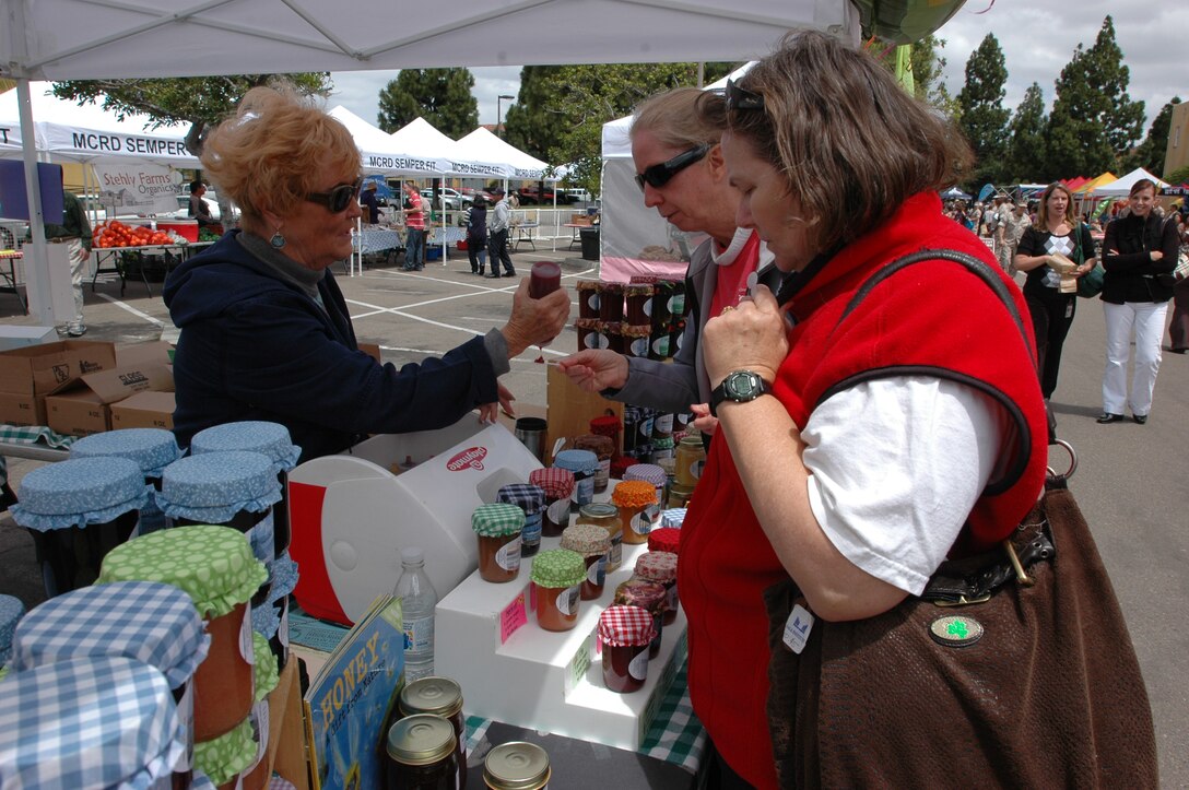 Kathy Springer and Tricia Grame sample the different flavors of honey that Jackie’s Jam has to offer at the Fitness and Wellness Expo, Tuesday, May 11. Pat Vacio squeezed different types of honey onto small spoons for the ladies to taste.