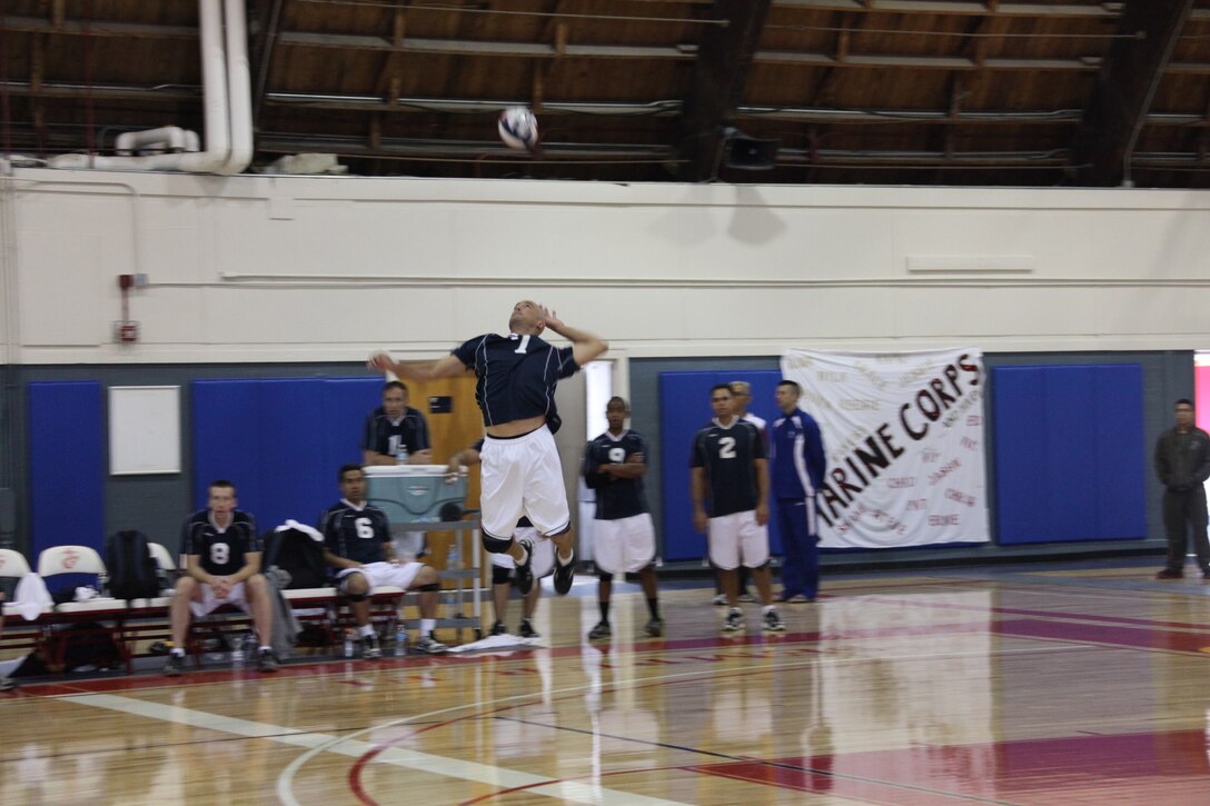 John Goings, setter for the Navy men’s indoor team, serves a lofting shot during the indoor volleyball tournament, May 11. Both the beach and the indoor tournaments were a part of the Armed Forces Volleyball Championship, and the Navy took silver over all for both men and women.