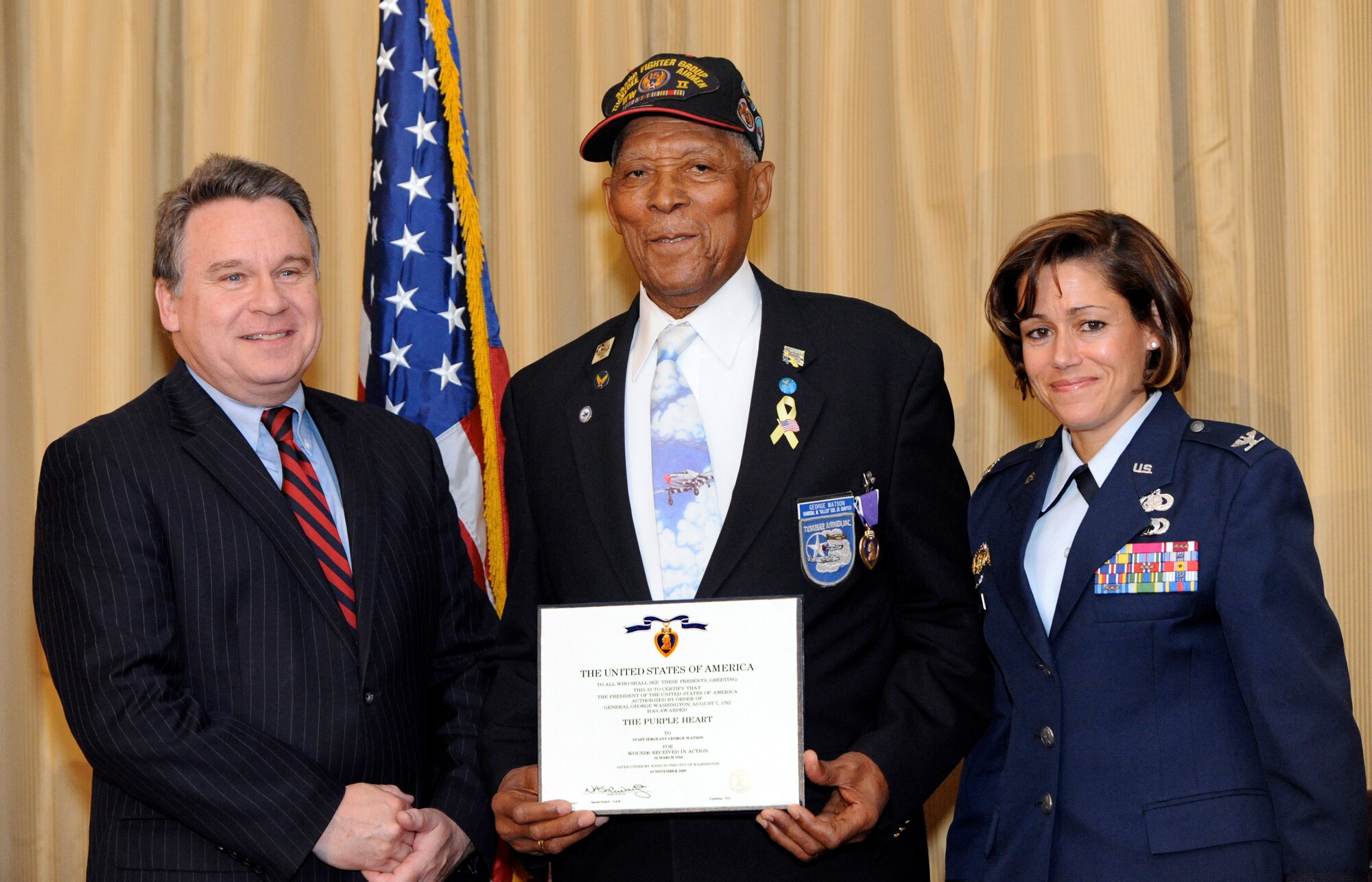 Tuskegee Airman Tech. Sgt. (Ret.) George Watson Sr. is presented the Purple Heart medal by Congressman Christopher Smith and Col. Gina M. Grosso, Joint Base McGuire-Dix-Lakehurst commander,  May10 here. He received the medal for injuries he sustained more than 66 years ago after a German air raid on his encampment near Naples, Italy. (U.S. Air Force photo/Wayne Russell)