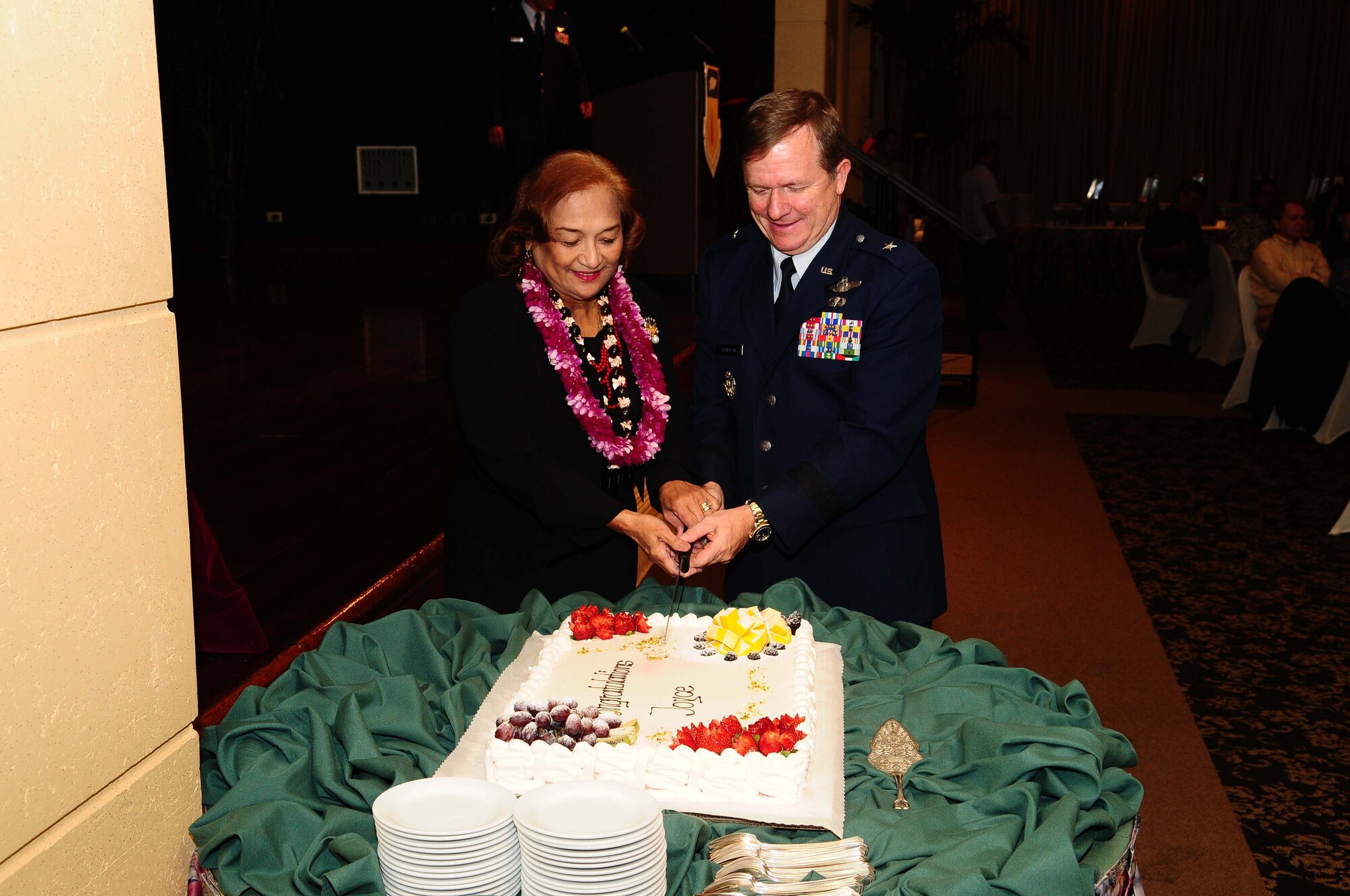 TUMON, Guam - Joyce Martratt, 36th Wing administrative assistant, cuts the ceremonial cake with Brig. Gen. Phil Ruhlman, 36th Wing commander, during her recognition luncheon for her 44 years of civilian service here May 7. Mrs. Martratt was recognized for her outstanding service for the Air Force by friends, family and Team Andersen members. (U.S. Air Force photo by Airman 1st Class Jeffrey Schultze)